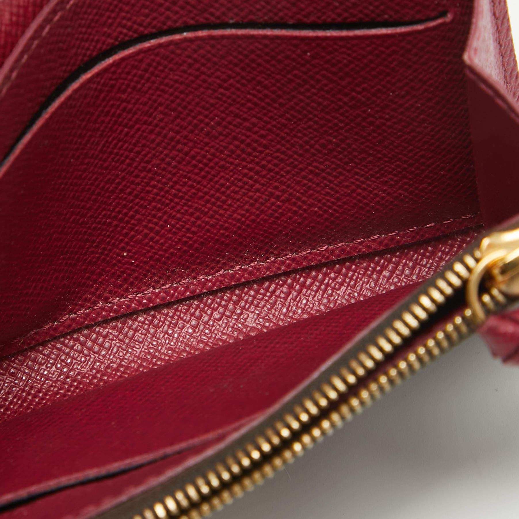 Crafted from the brands signature Monogram coated canvas this Rosalie coin purse has a feminine design aesthetic. It has a soft round flap that opens to reveal a leather interior with card slots and a zip pocket for coins. The exterior also features