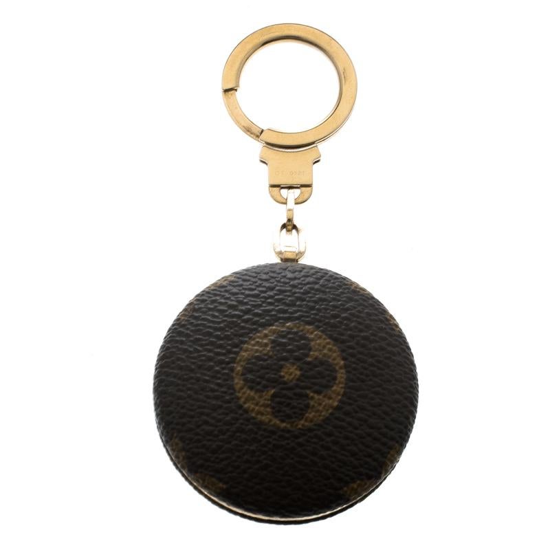 When it comes to Louis Vuitton, all their creations are worth loving. This round key chain is crafted from LV's signature monogram canvas and features a gold-tone ring that has the brand name engraved on it. Whether you accessorize it with a travel