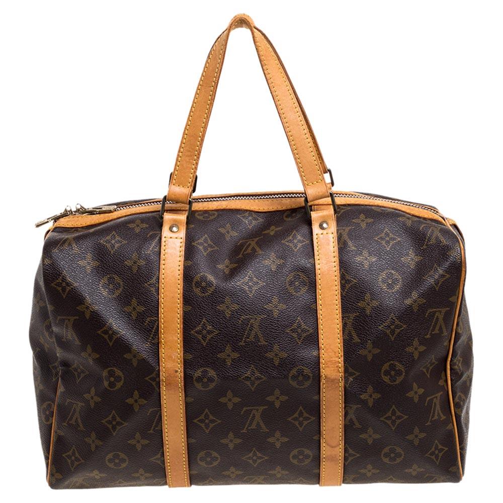 This classic piece from the house of Louis Vuitton is great for travel or short trips. It is brilliantly crafted with the label's signature monogram canvas body and detailed with leather trims. Featuring dual zip closure, this bag offers ample room