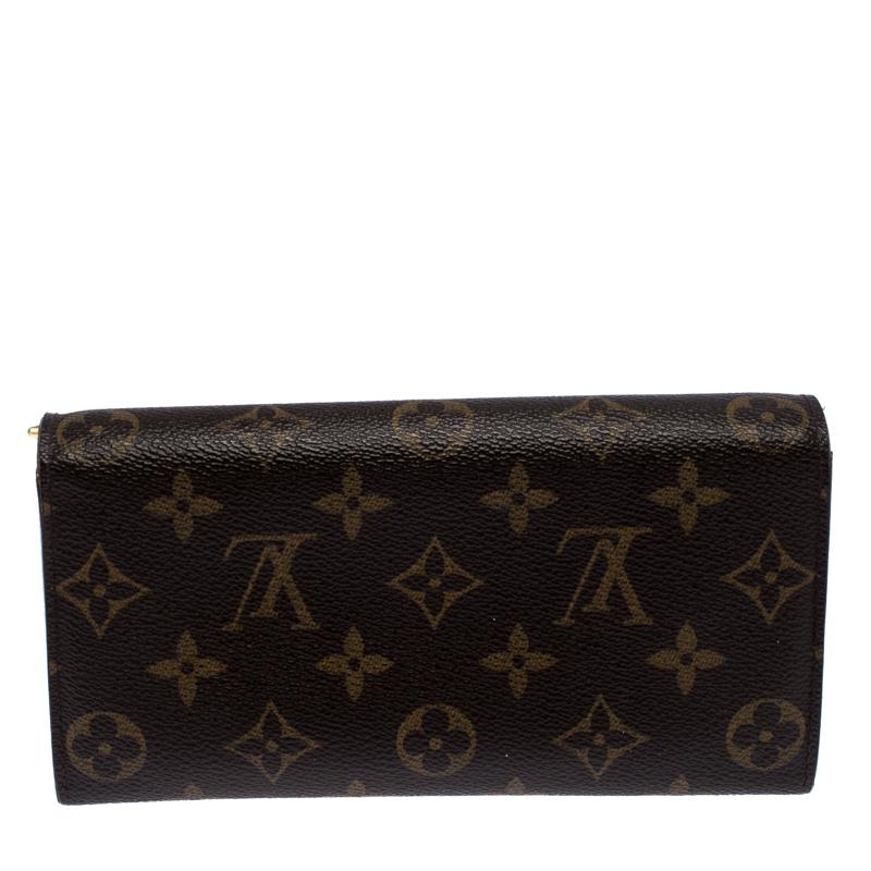 One of the most famous wallets by Louis Vuitton is the Sarah continental wallet. This one here comes made from the brand's signature Monogram coated canvas and the button on the flap opens to an interior with multiple card slots and a zip pocket.