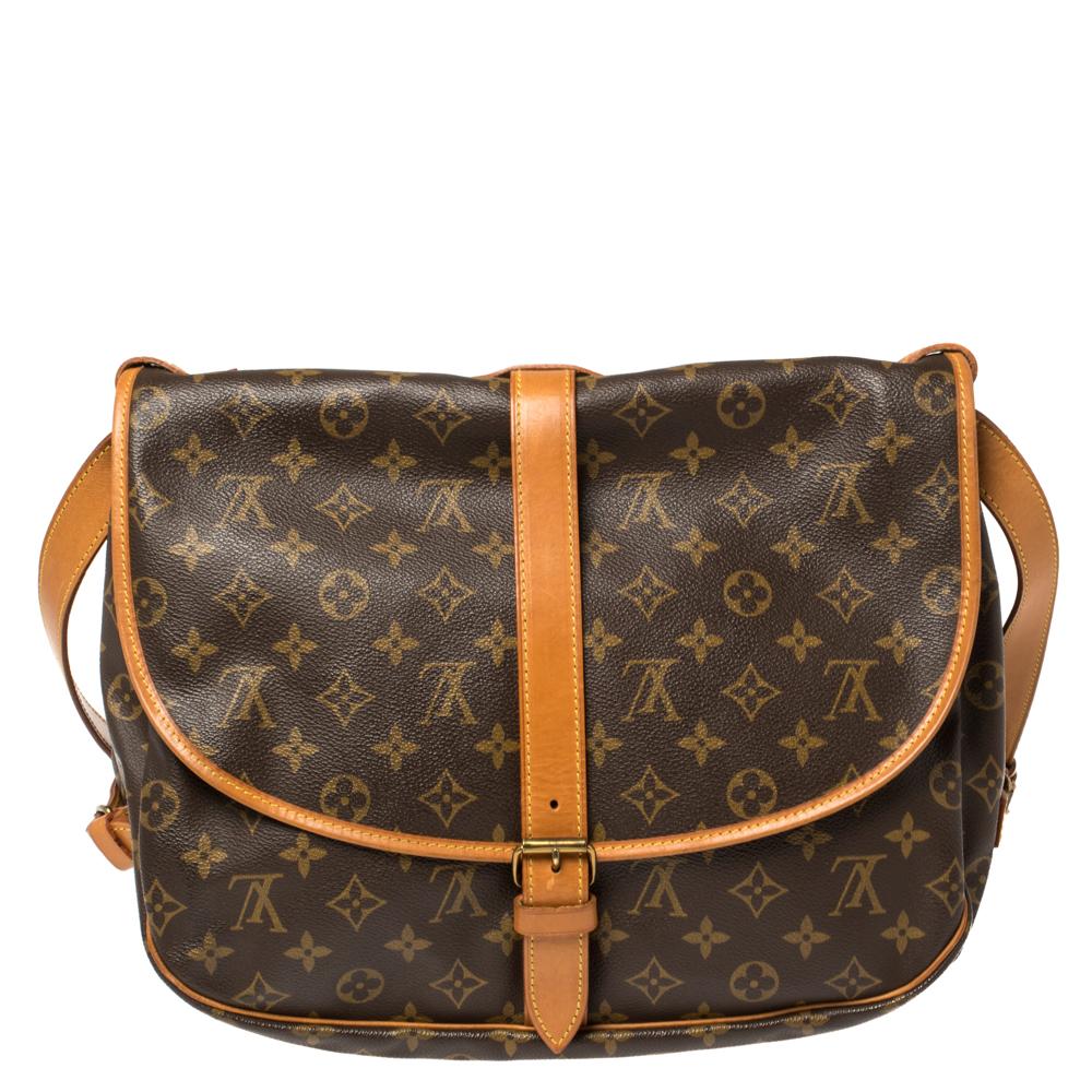 Inspired by equestrian ‘SADDLE’ design, this legendary messenger bag by Louis Vuitton is crafted from monogram canvas and will never go out of style. This bag features dual compartments, held together tightly with belts on the sides. Its adjustable