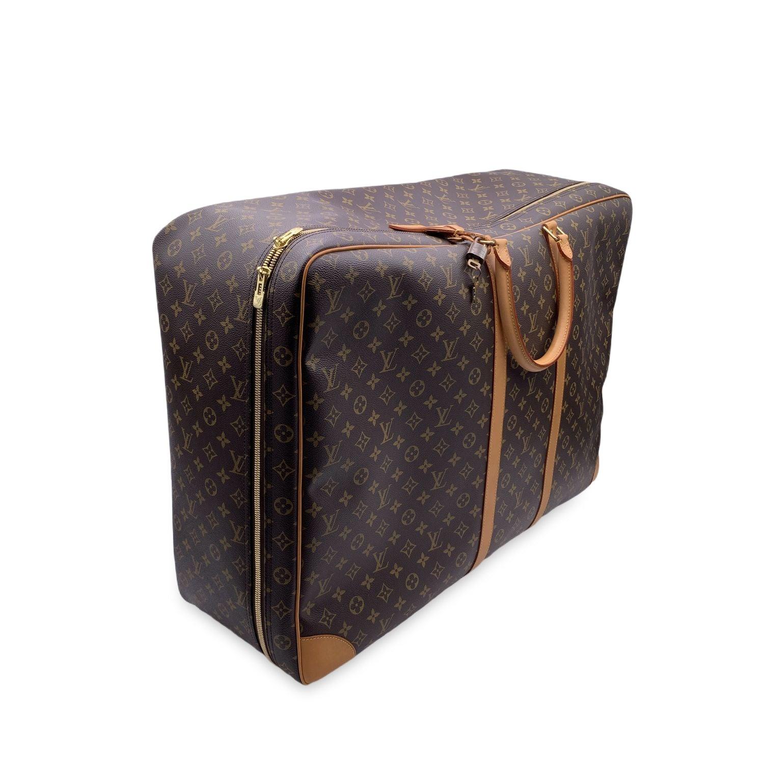 Splendid Louis Vuitton soft-sided SIRIUS 70 suitcase crafted in classic and timeless brown Monogram canvas. It features gold-tone hardware, natural cowhide leather trim and accents, double rolled leather handles and a full double zipper closure.