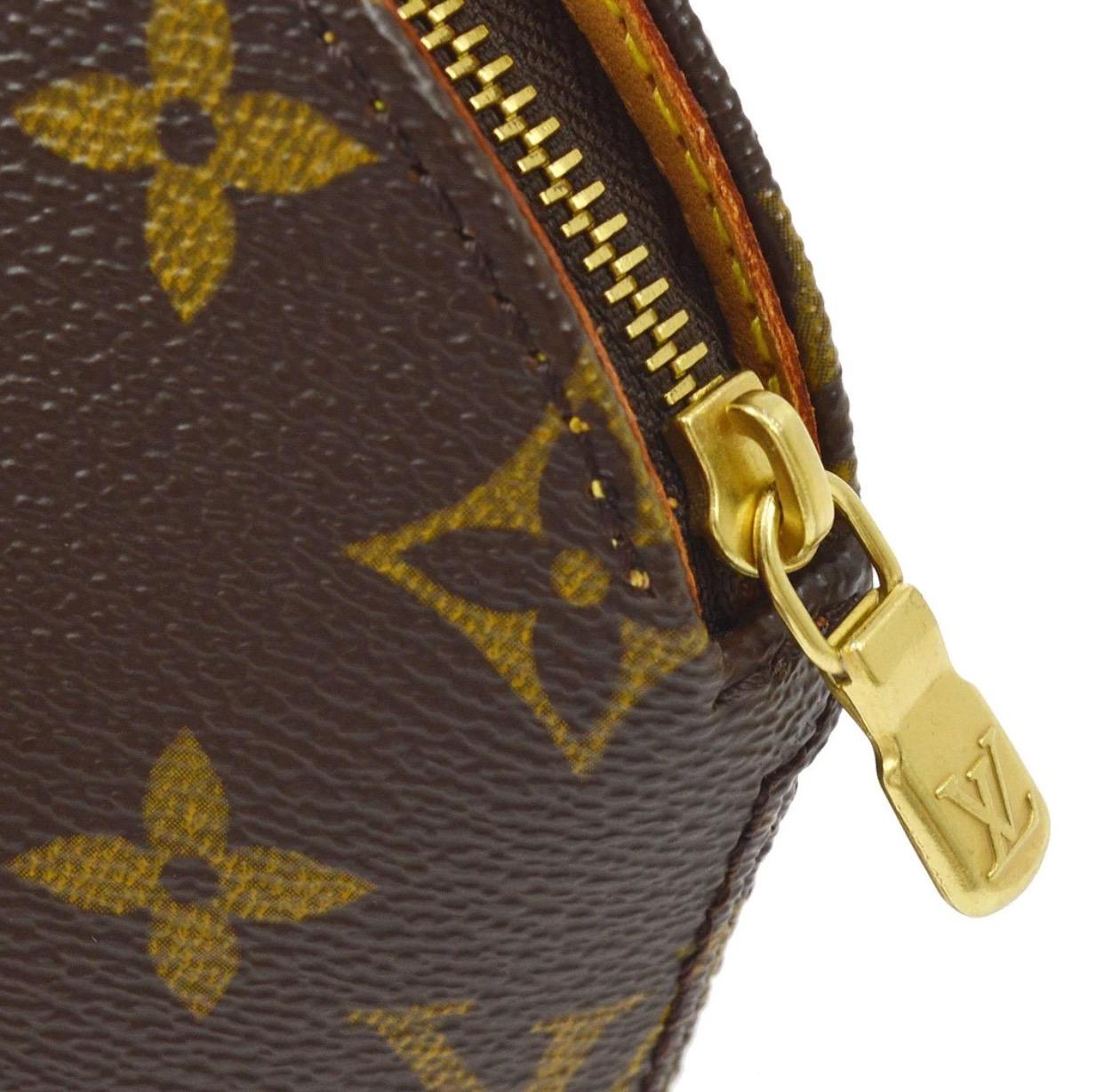 Monogram canvas
Leather
Gold tone hardware
Woven lining
Zipper closure
Date code present
Measures 4.25