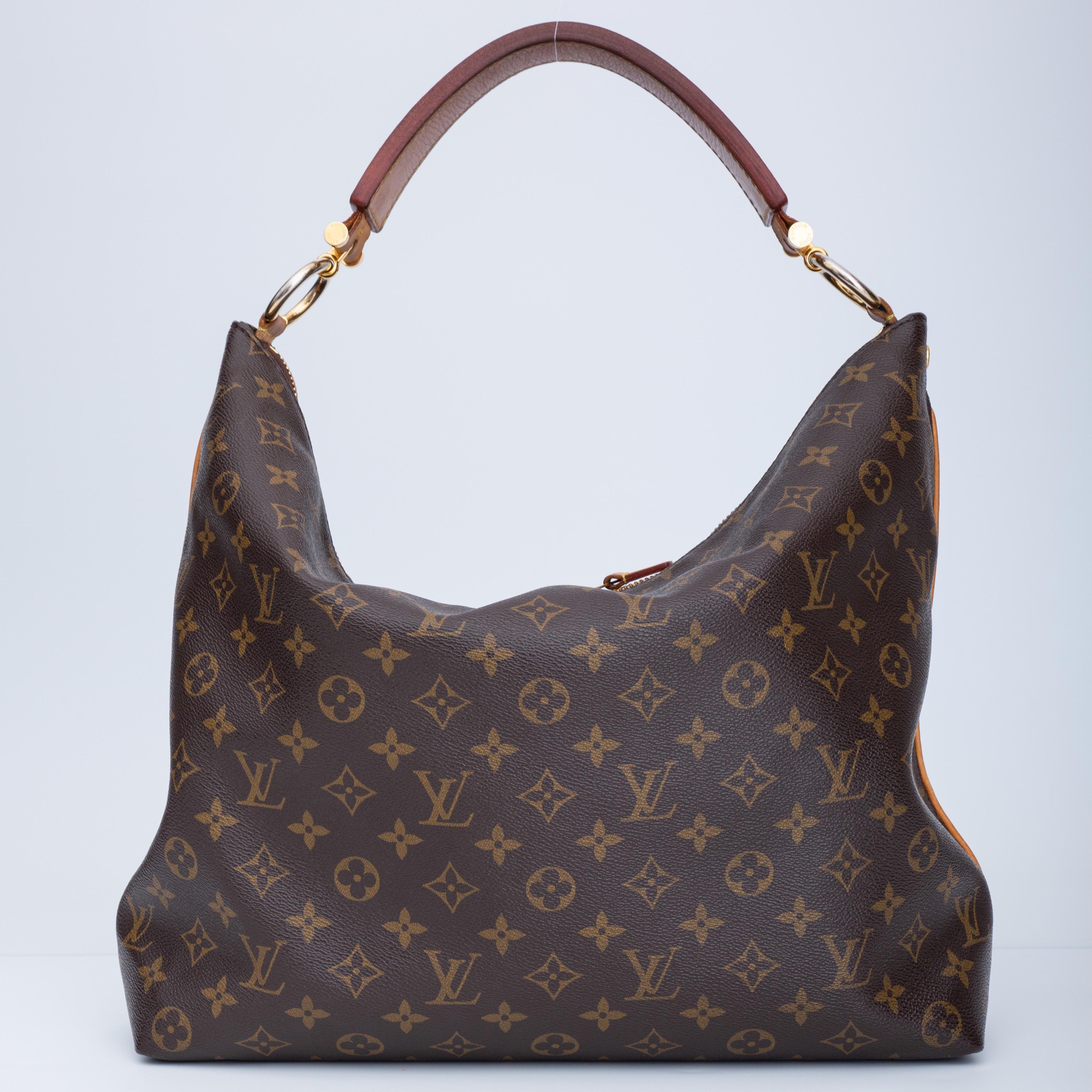 This tote bag is made of coated canvas with lv’s monogram print. The bag has a hobo relaxed shape, a flat leather top handle, gold tone circular links connecting the top handle, top zip closure with double zippers and brown woven fabric with silk