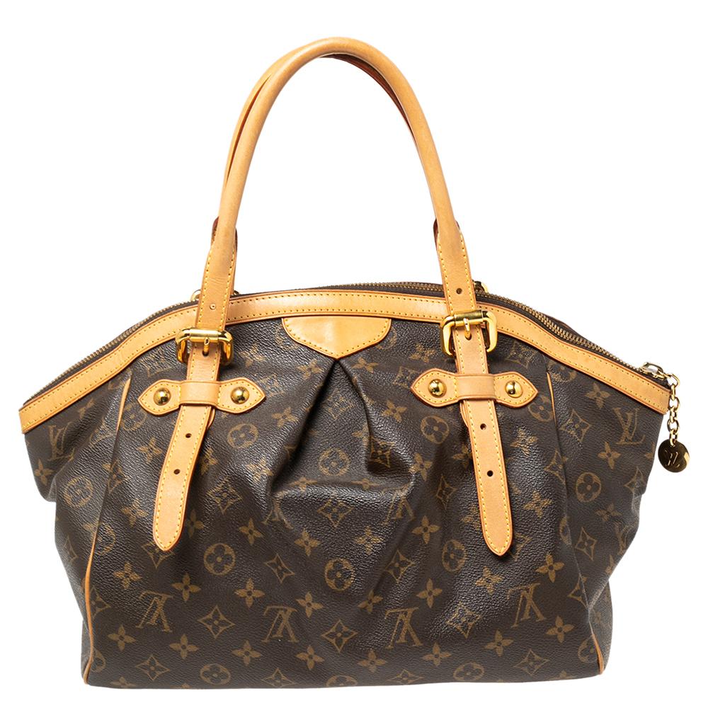 From the house of Louis Vuitton comes this gorgeous Tivoli bag that is both stylish and handy. Crafted from monogram canvas, the bag has leather trims, two leather handles, and protective metal feet. It has a top zipper that opens to reveal a