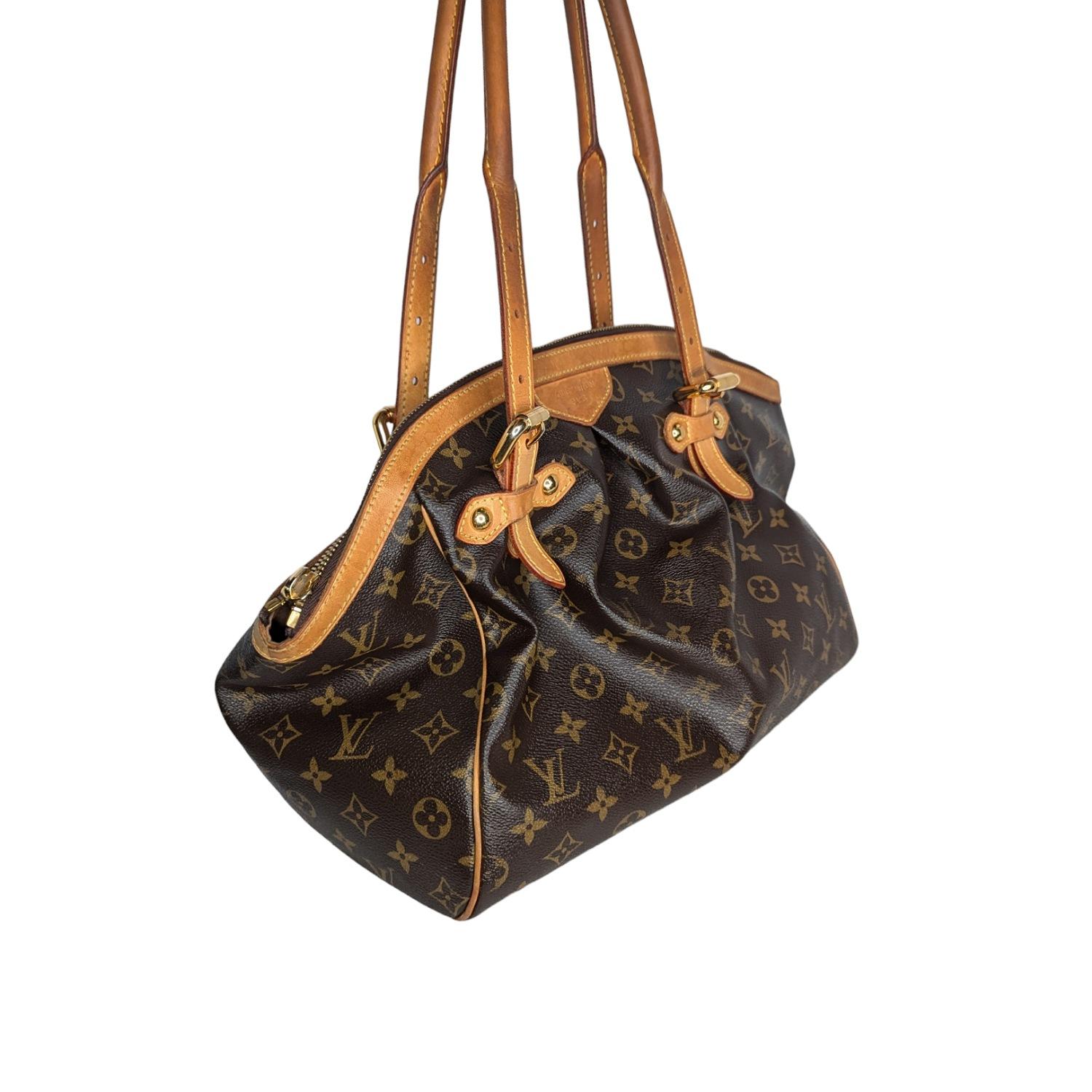 Elevate your style with this iconic and discontinued Louis Vuitton Tivoli GM satchel. Crafted from the brand's signature monogram canvas and complemented by rich cowhide leather, this timeless piece exudes luxury. With ample interior space and