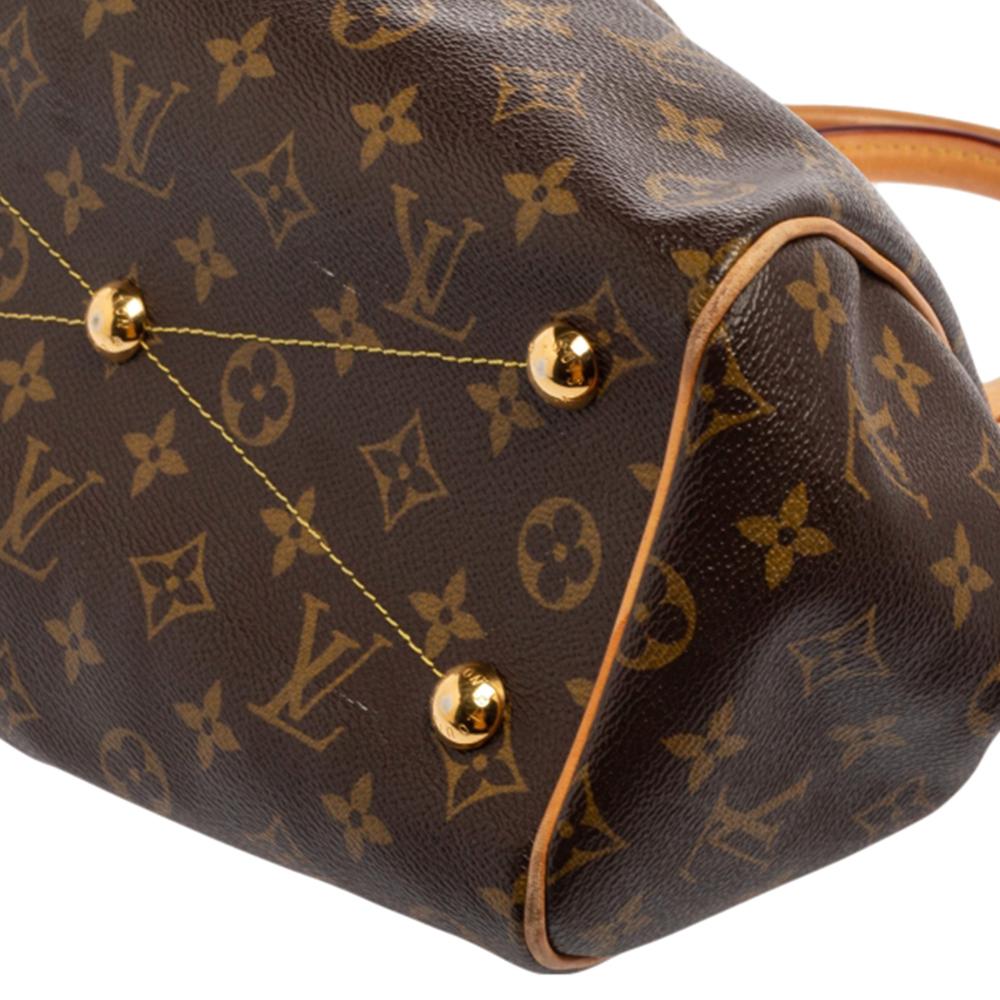 From the house of Louis Vuitton comes this gorgeous Tivoli bag that is both stylish and handy. Crafted from monogram canvas, the bag has leather trims, two leather handles, and protective metal feet. It has a top zipper that opens to reveal a