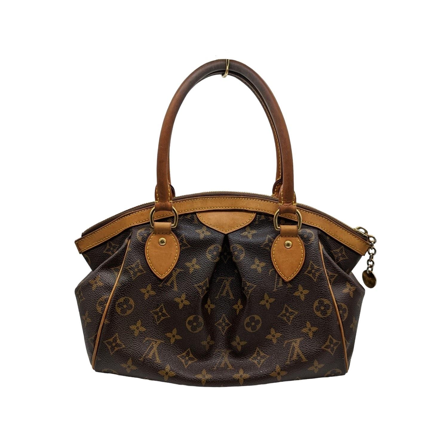 This stylish tote is finely crafted of pleated Louis Vuitton monogram on toile canvas. The shoulder bag features signature natural vachetta leather trim, rolled handles and polished brass hardware. The top zipper opens to a cocoa brown fabric