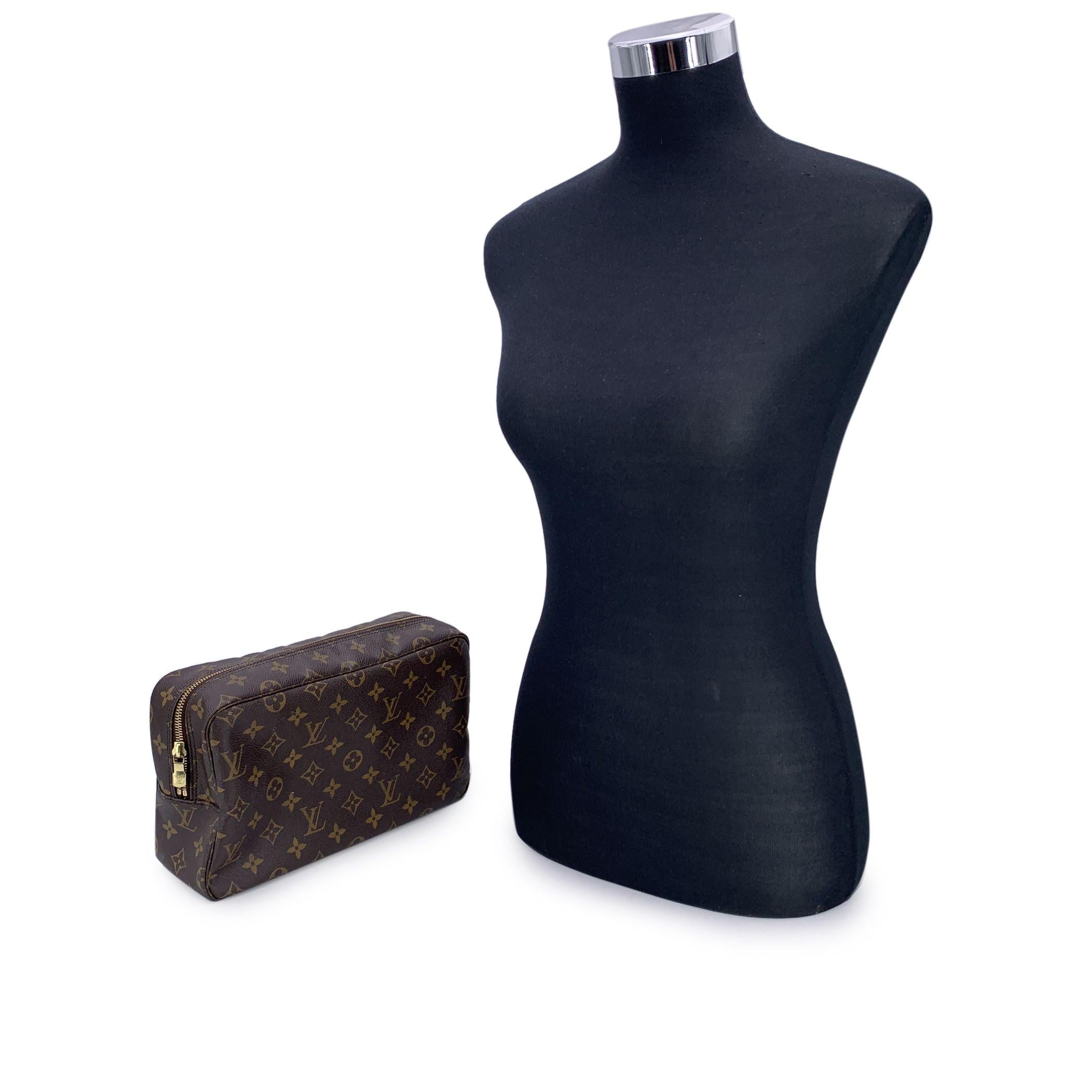 Discover the perfect blend of functionality and luxury with this LOUIS VUITTON Monogram Trousse Toiletry 28 Cosmetic Bag. A true gem for lovers of classic design, this elegant bag is crafted from Louis Vuitton's signature brown monogram coated