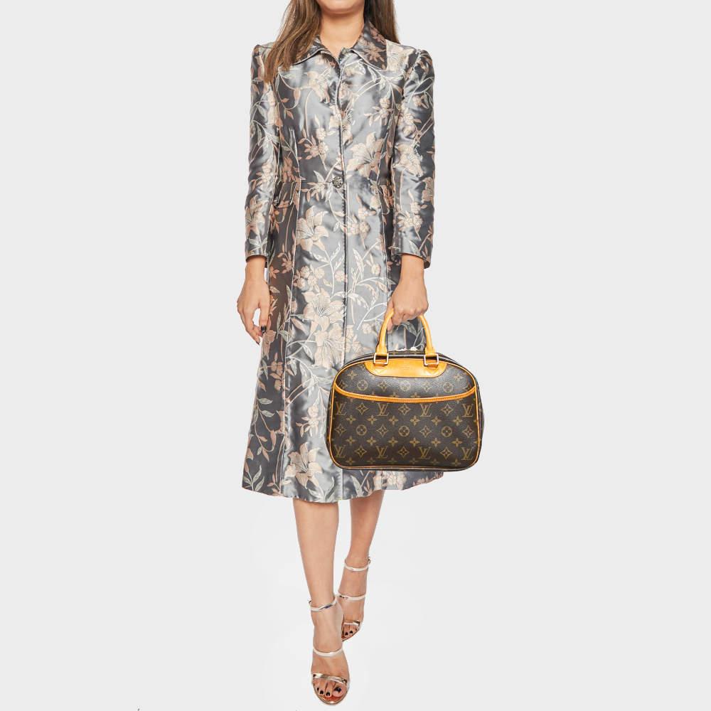 This authentic LV Trouville bag has been designed to be a forever kind of style companion Fashioned in Monogram canvas and leather  the bag can be elegantly paraded using the shapely handles.