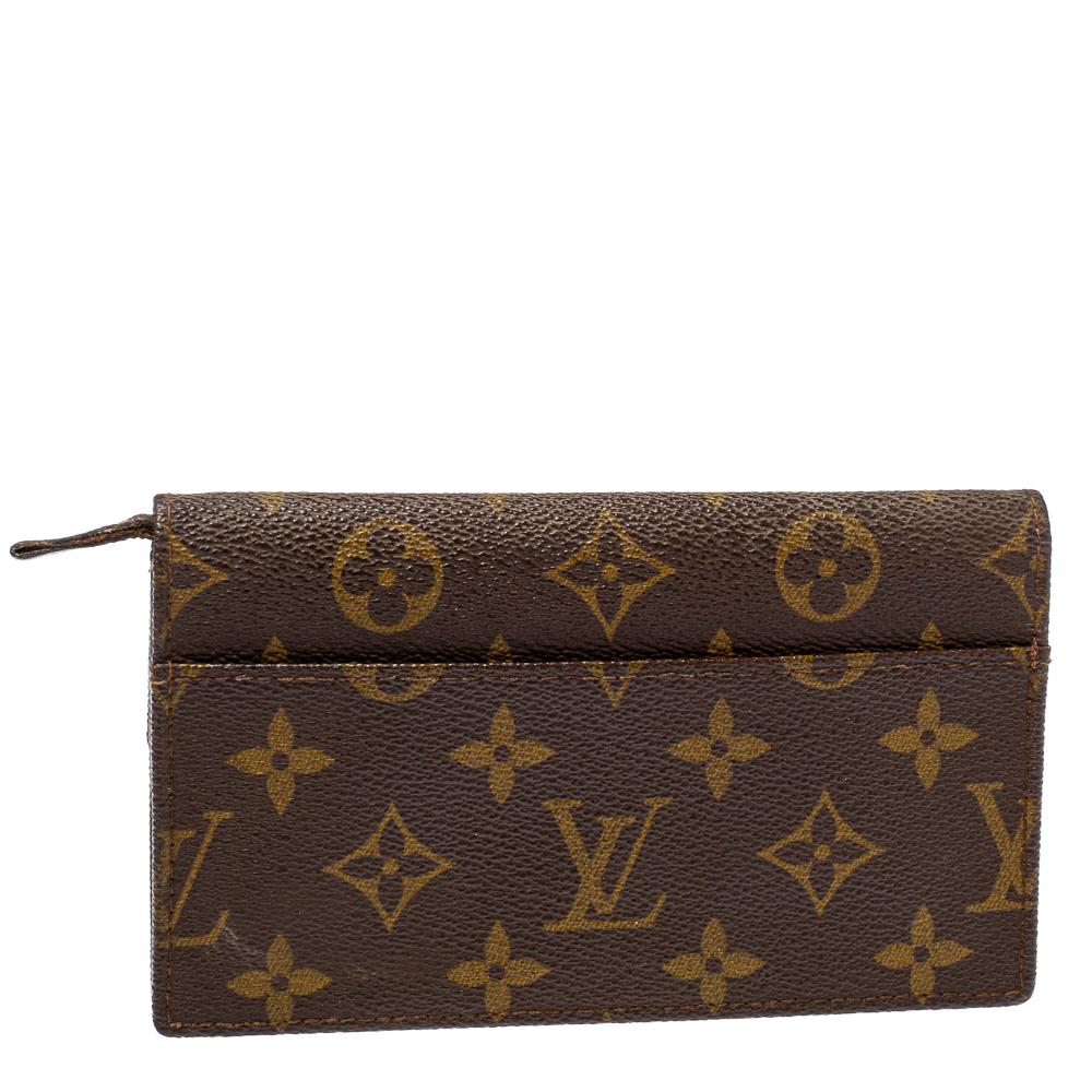 Stay organized in style with this wallet from Louis Vuitton. It is crafted from monogram coated canvas, and it has a flap with a snap button. The wallet features two compartments for your cash, coins, and cards.

