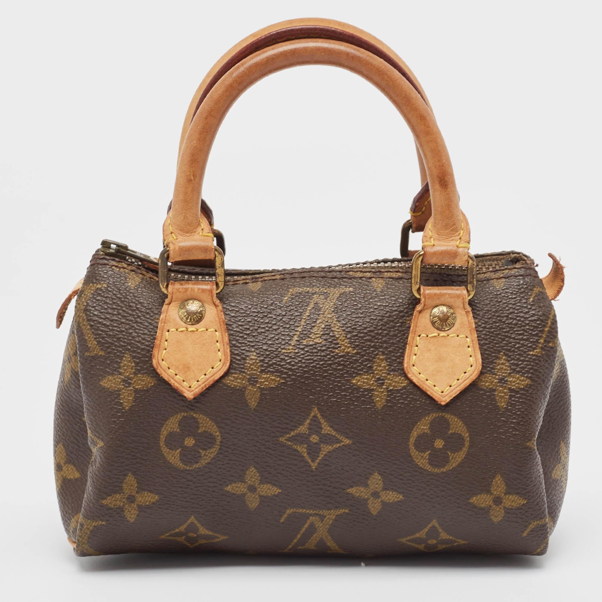 This Louis Vuitton Speedy may be tiny but it delivers an unmissable style statement. It is made of Monogram canvas and held by leather handles.

Includes: Brand Dustbag