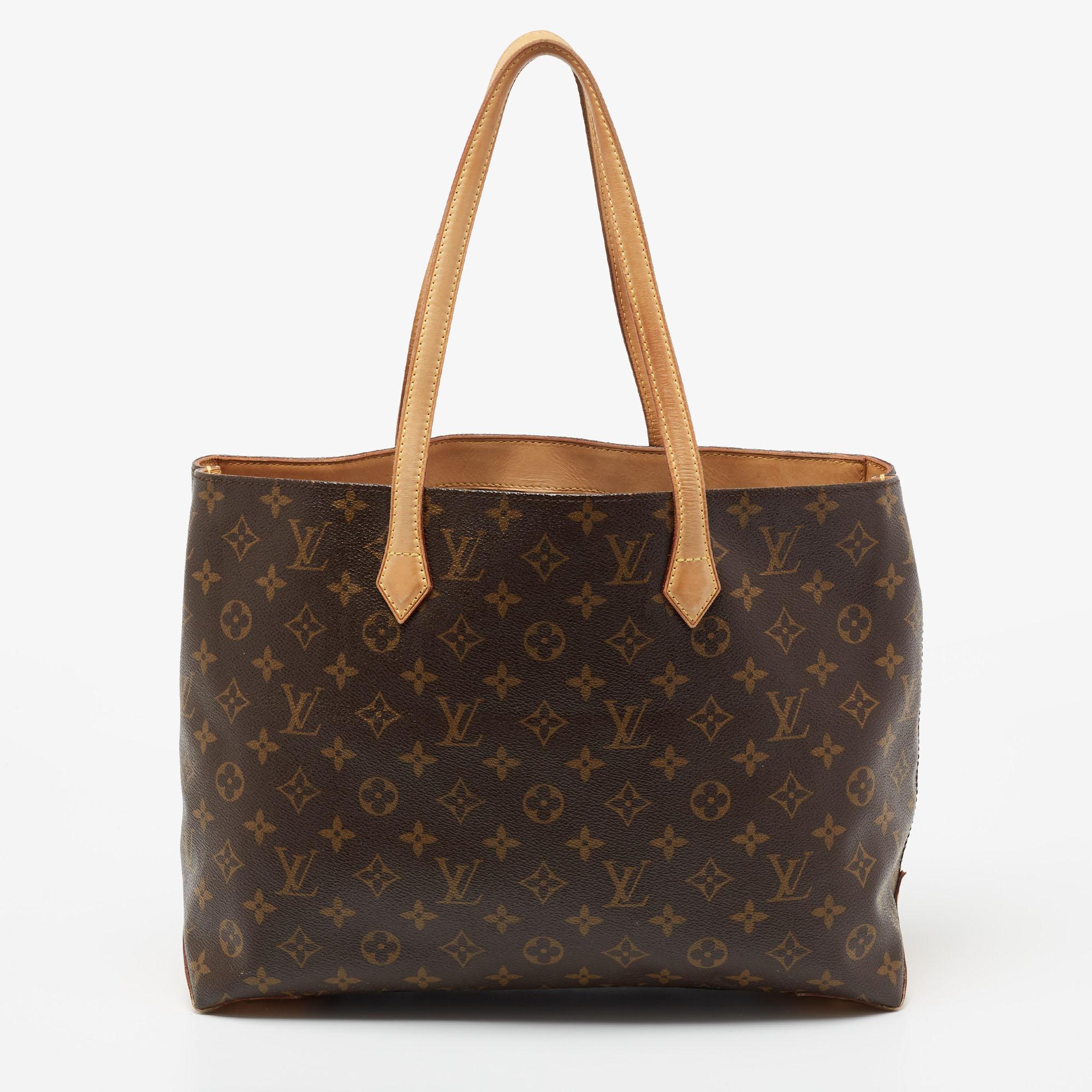 Louis Vuitton's handbags are popular owing to their high style and functionality. This Wilshire bag, like all the others from the brand, is durable and chic. Crafted from coated canvas, the brown bag comes with dual handles and opens to reveal a