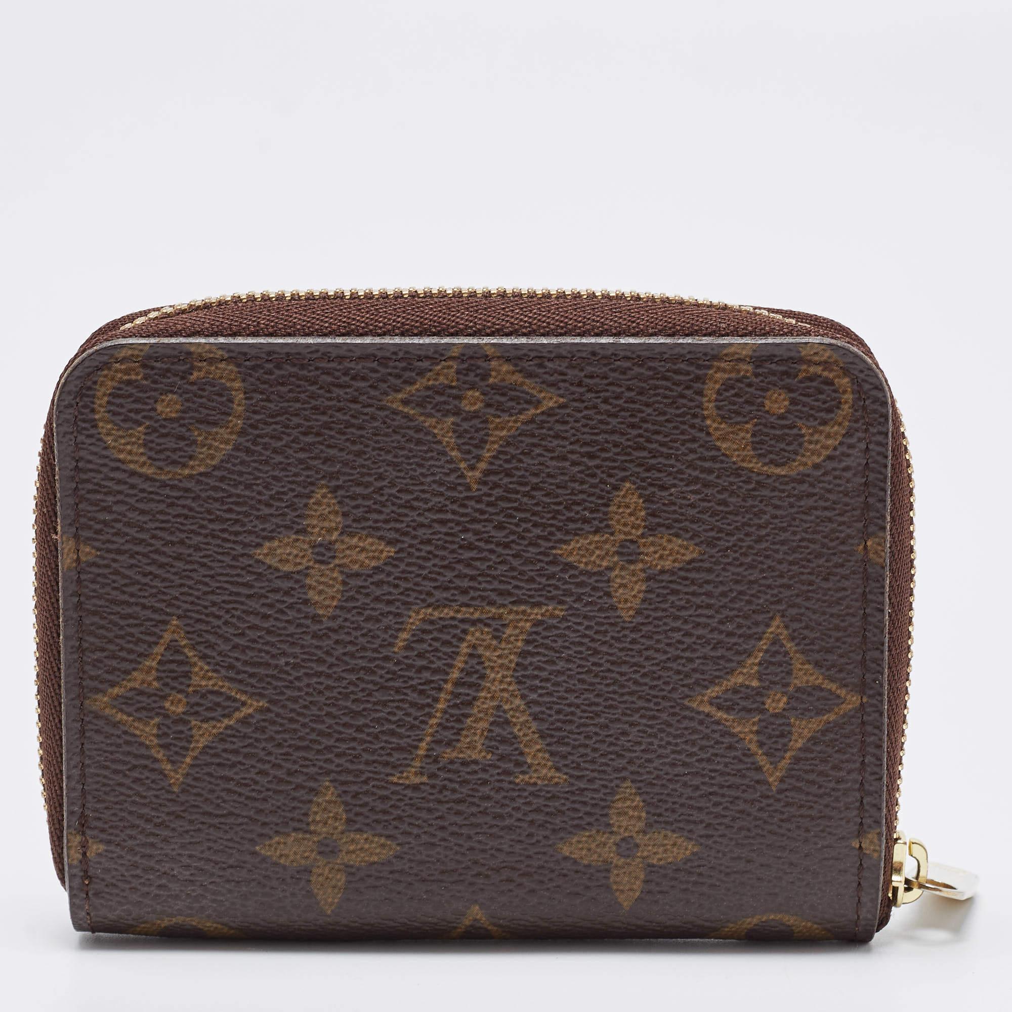 This Louis Vuitton Zippy coinpurse is conveniently designed for everyday use. Crafted from monogram coated canvas, the wallet has a zip closure which opens to reveal multiple slots for you to neatly arrange your cards and coins.

