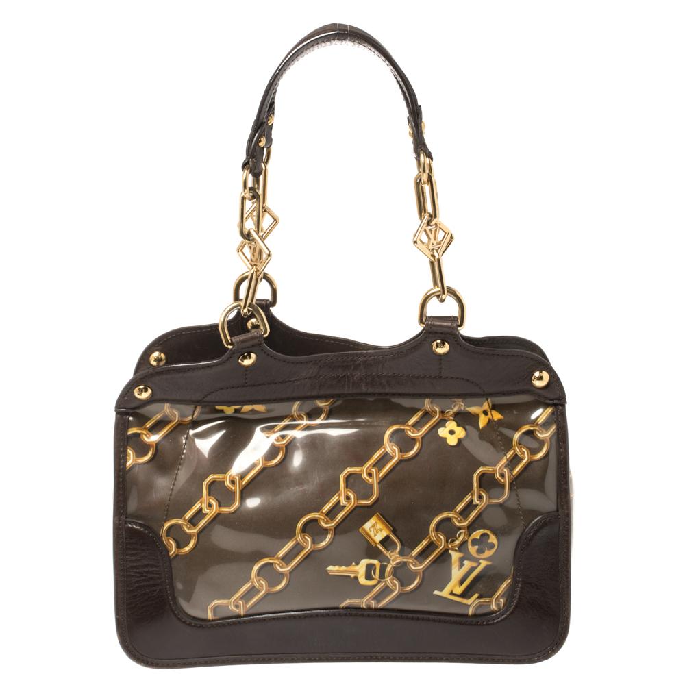This limited edition creation is for all Louis Vuitton collectors and lovers alike. Meticulously crafted from monogram charms and chain-link coated vinyl and brown leather, this dream bag is held by two handles featuring logo accents. It comes in a