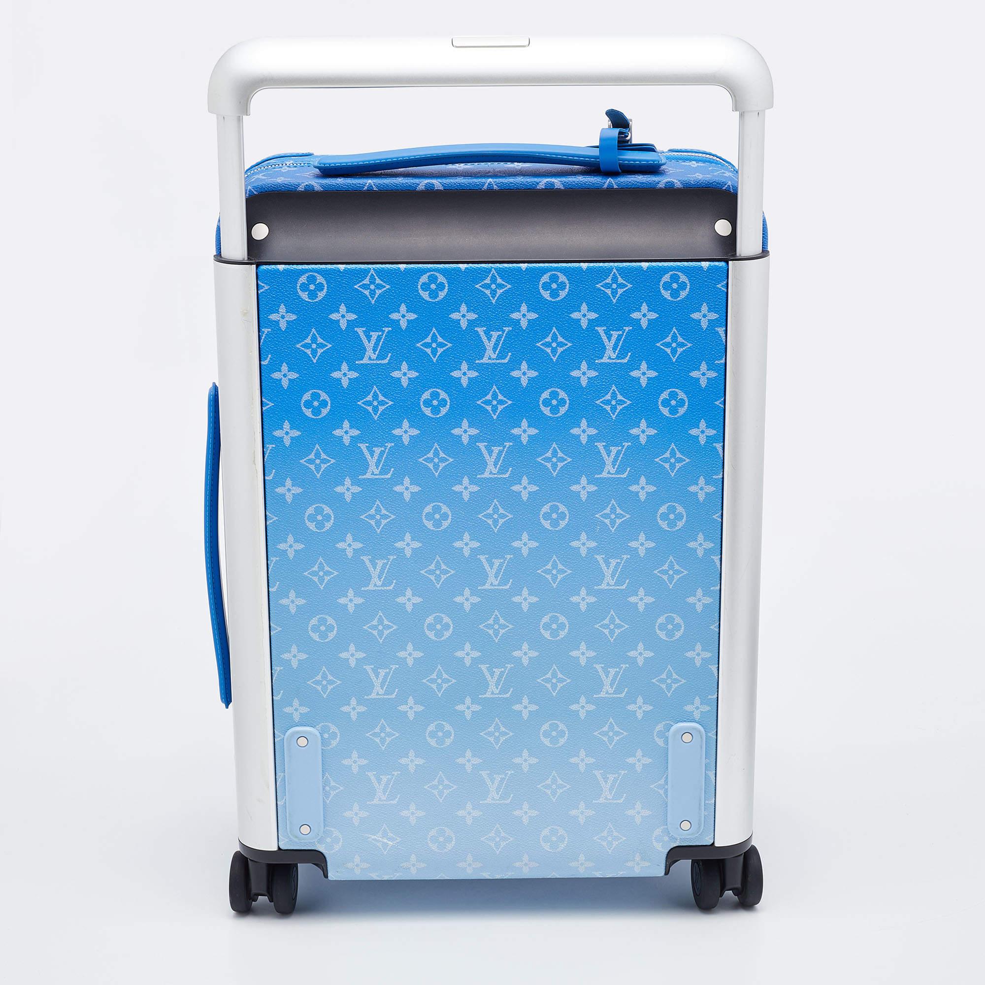 Match your travel essentials to your personal style with this luxurious designer suitcase from Louis Vuitton. It is the Louis Vuitton Monogram Clouds Horizon 55 in a dreamy blue. It has four wheels, a telescopic handle, and a matching luggage