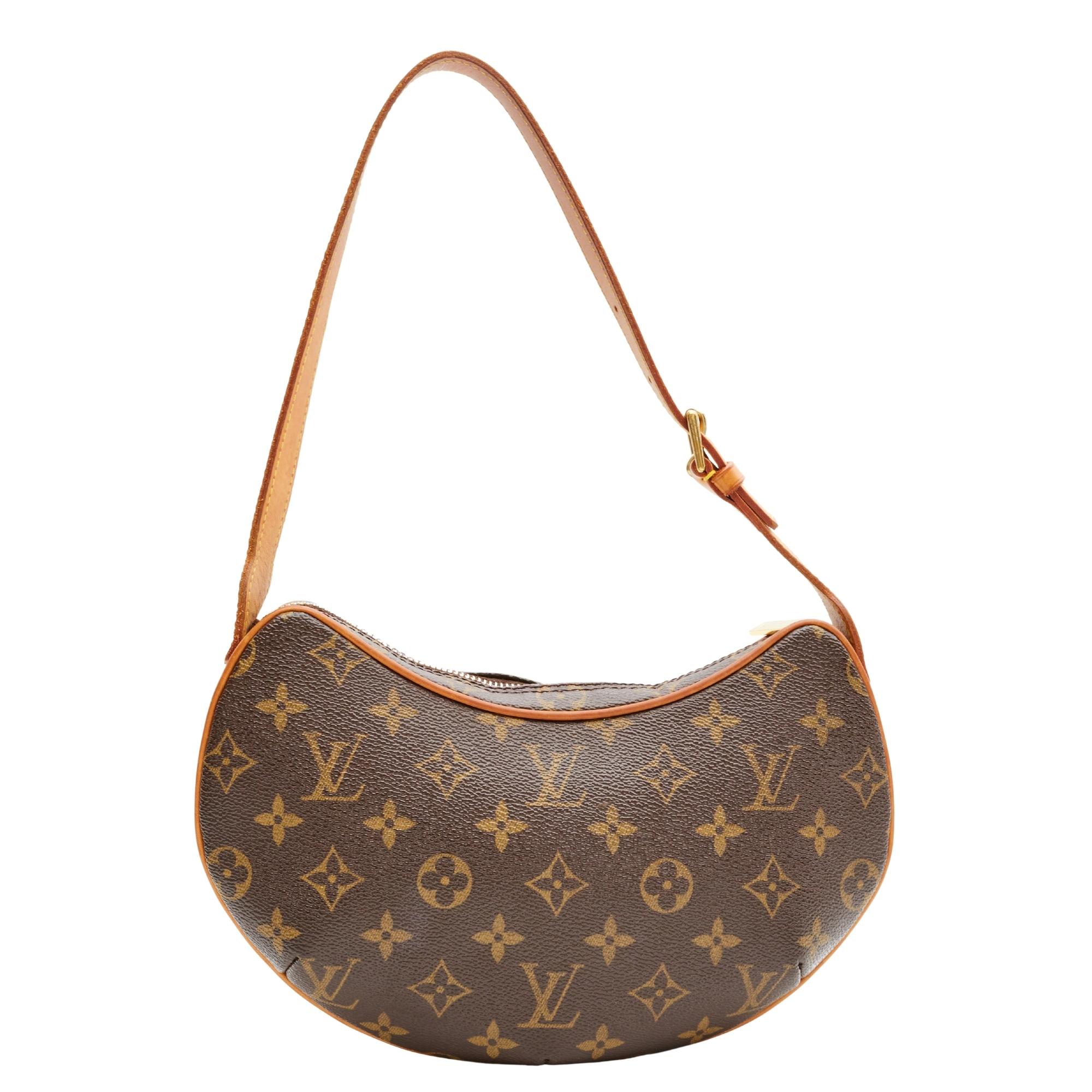 This pochette is made with classic Louis Vuitton monogram coated canvas. The bag features a vachetta cowhide leather trim and details, a looping leather top handle, polished brass hardware, top zip closure and a rouge red microfiber interior with a