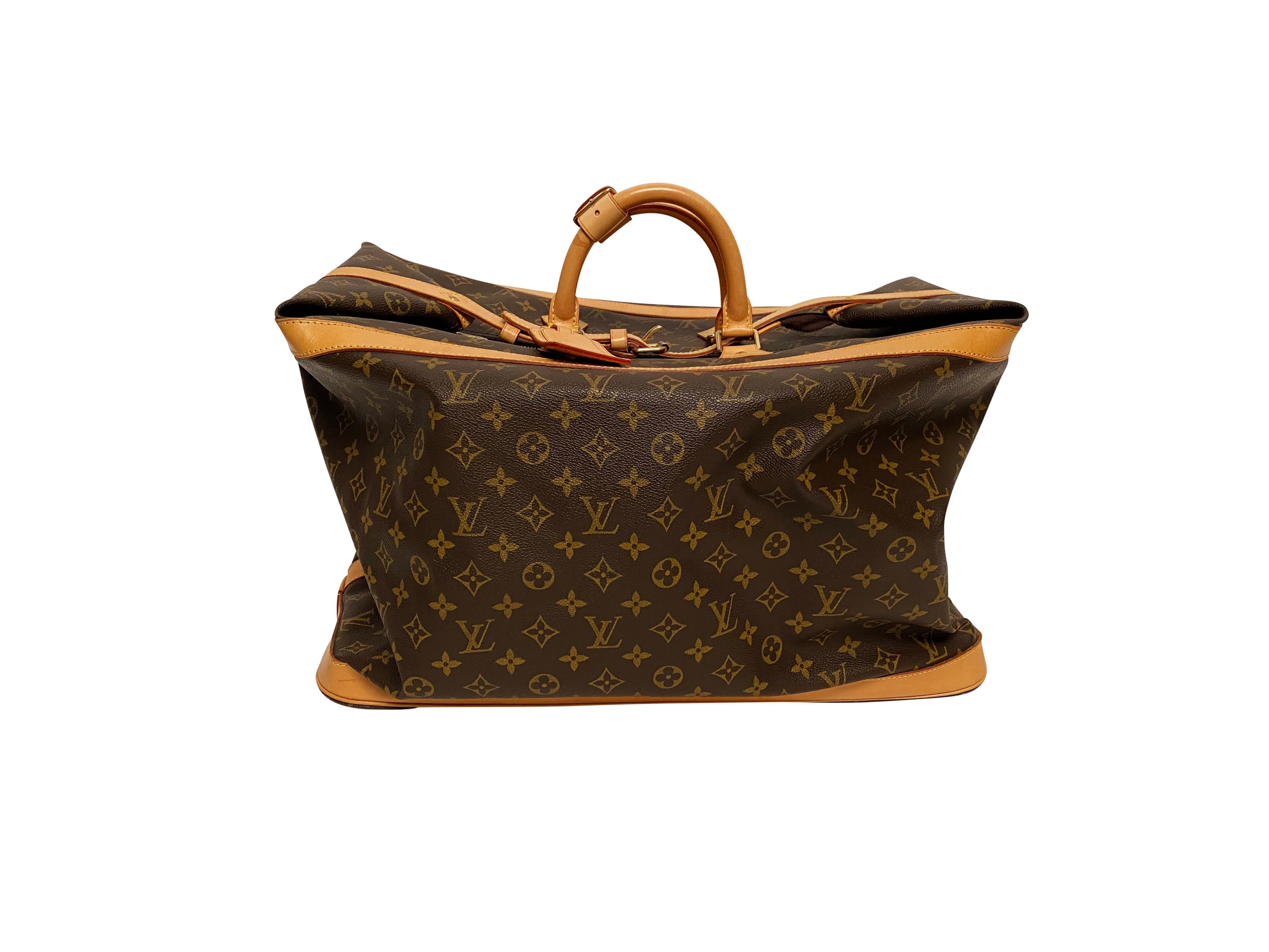1999 Louis Vuitton vachetta leather and canvas monogram Cruiser 50 travel bag with canvas interior.

This inconic LV duffle bag features dual rolled vachetta leather handles with buckle for extra security, gold toned hardware, and full zip closure