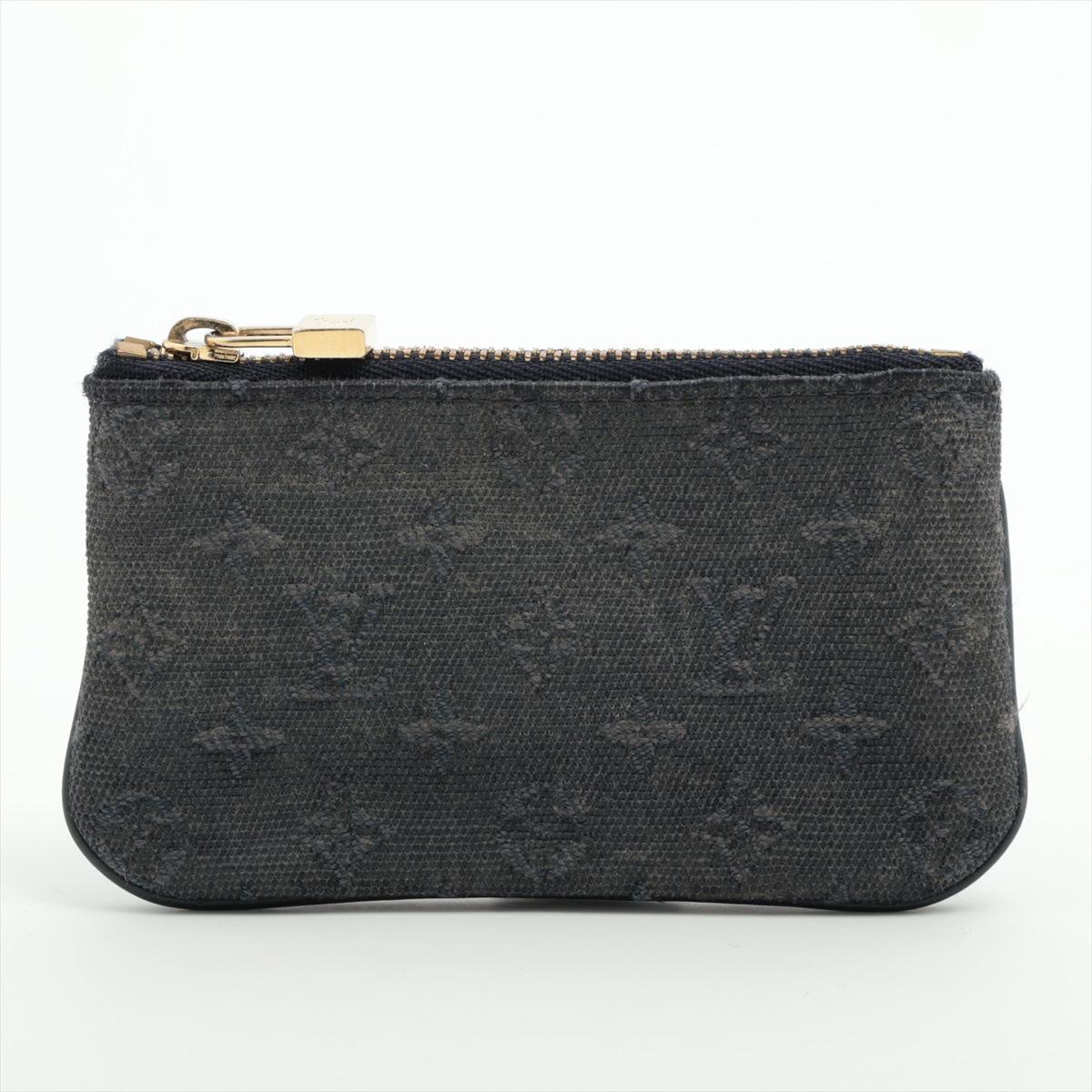 The Louis Vuitton Monogram Denim Coin Purse in Black is a sleek and practical accessory designed for everyday use. Crafted from durable denim fabric with the iconic Louis Vuitton Monogram pattern, the coin purse exudes sophistication and style. Its