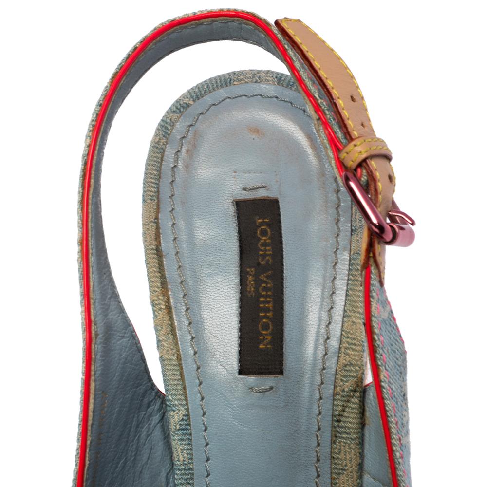 Stylishly chic, these sandals by Louis Vuitton can be worn through the day with utmost ease. With a bleached monogram denim exterior accented with contrasting red trims, these sandals feature buckled strap detailing on the front. They come with