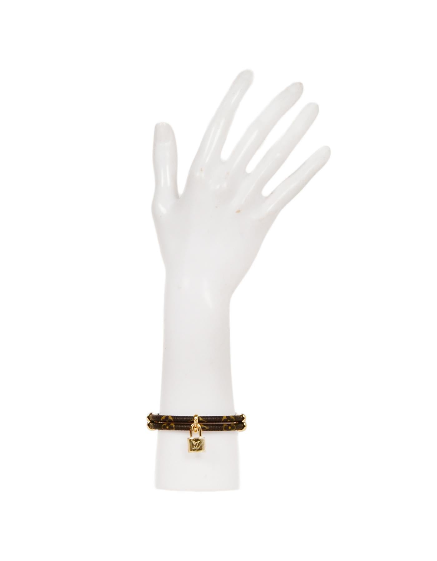 Louis Vuitton Monogram Double Keep It Twice Logo Lock Bracelet 
Made In: Spain
Color: Brown
Materials: Coated Canvas
Hallmarks: BC 1107
Closure/Opening: Clasp closure
Overall Condition: New
Estimated Retail: $405 + tax
Includes: Box, dust