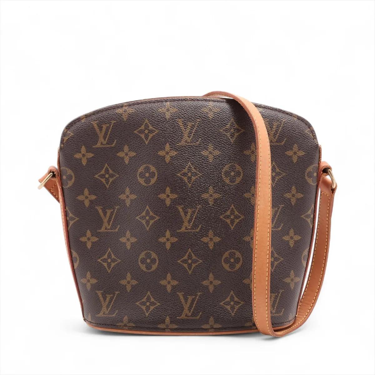 The Louis Vuitton Monogram Drouot Crossbody Bag is a chic and compact accessory that perfectly blends style and functionality. Crafted from the iconic Monogram canvas, the structured bag features a sleek, dome-shaped design that adds a touch of