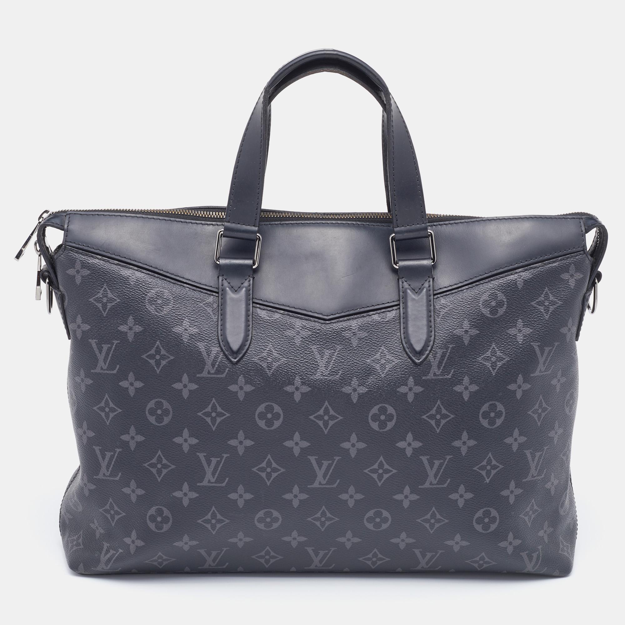 This luxe briefcase from Louis Vuitton is smooth, practical, and stylish for everyday use. Crafted from coated canvas and leather, it displays a zip closure, two handles, and a spacious fabric interior. For convenience, it is provided with an