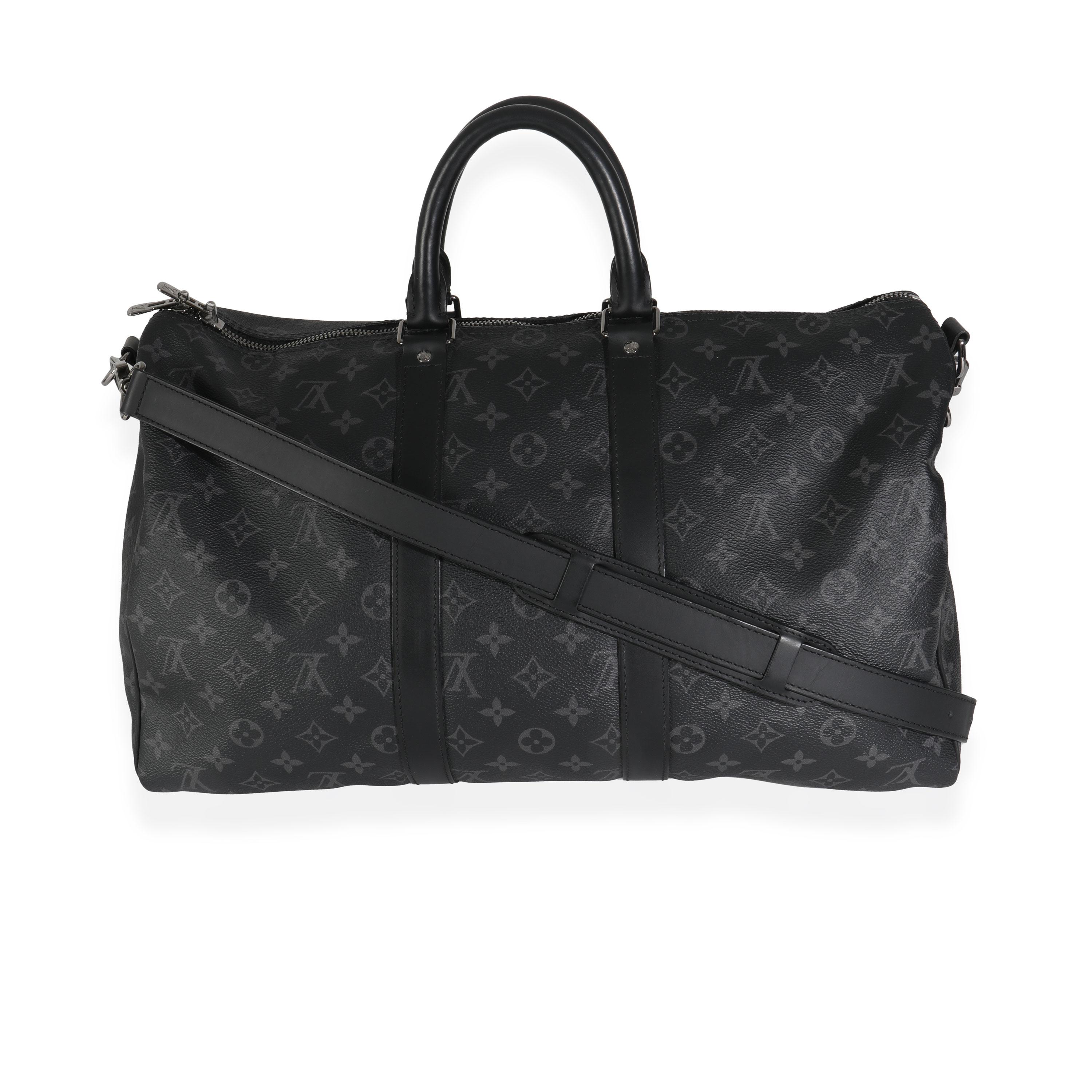 Listing Title: Louis Vuitton Monogram Eclipse Canvas Keepall Bandouliere 45
SKU: 144919
MSRP: 2490.00 USD
Condition: Pre-owned 
Condition Description: An early 20th-century design from Louis Vuitton, the Keepall bag is the epitome of the Maison's
