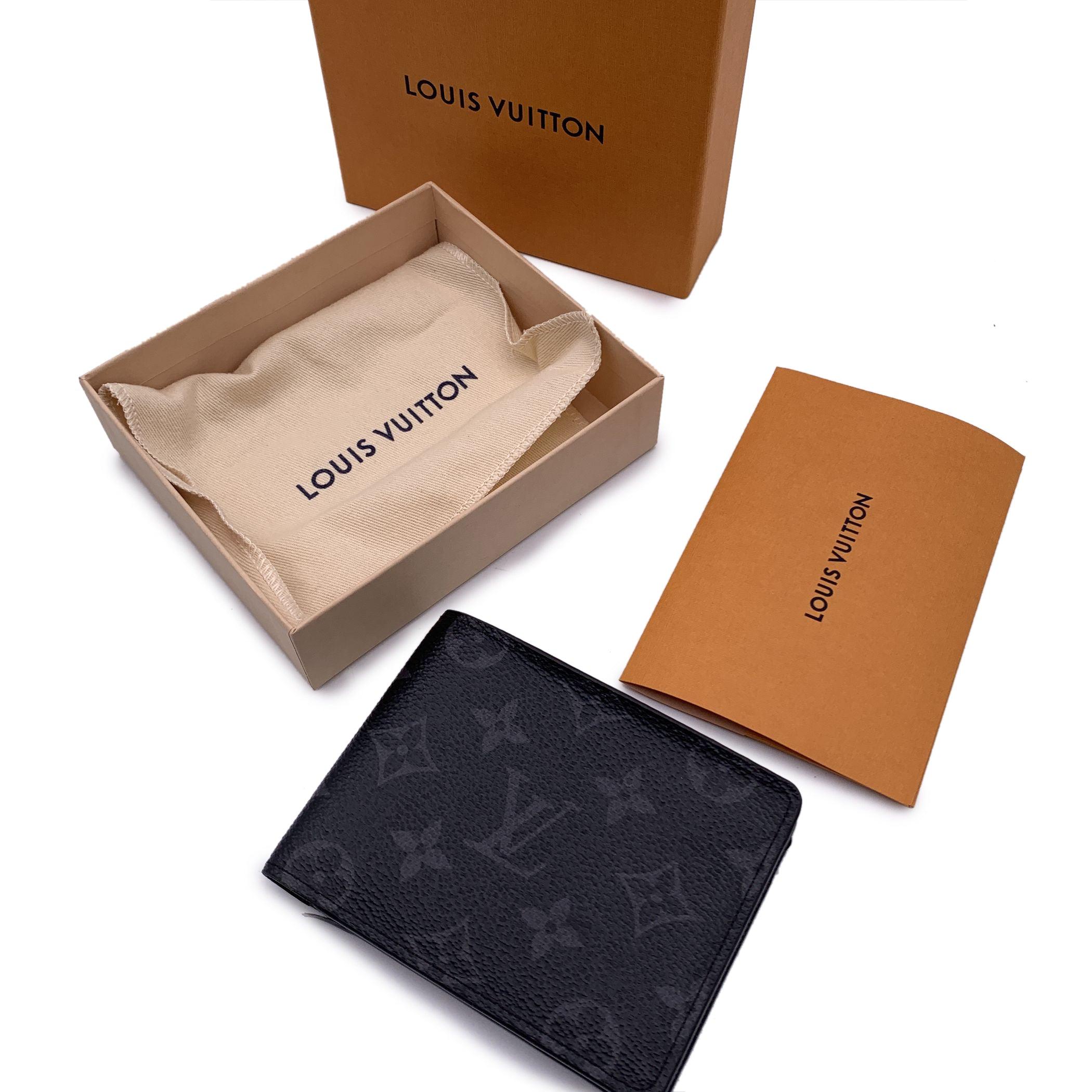 Louis Vuitton Monogram Eclipse canvas Multiple Bifold Wallet Credit Card Holder. Bifold design. 2 bill compartments, 5 credit card slots and 2 open pockets inside. Black leather lining. 'LOUIS VUITTON Paris - made in France' embossed inside.