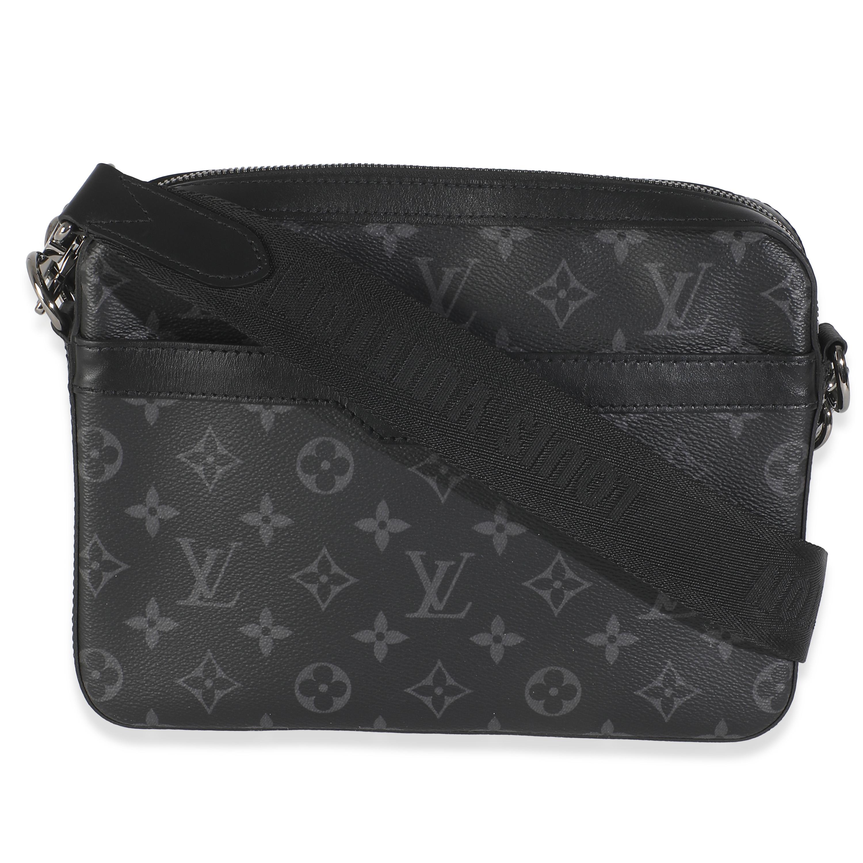 Listing Title: Louis Vuitton Monogram Eclipse Canvas Trio Messenger
SKU: 146209
Condition: Pre-owned 
Handbag Condition: Very Good
Condition Comments: Item is in very good condition with minor signs of wear.  Mini coin pouch Not Included. Faint