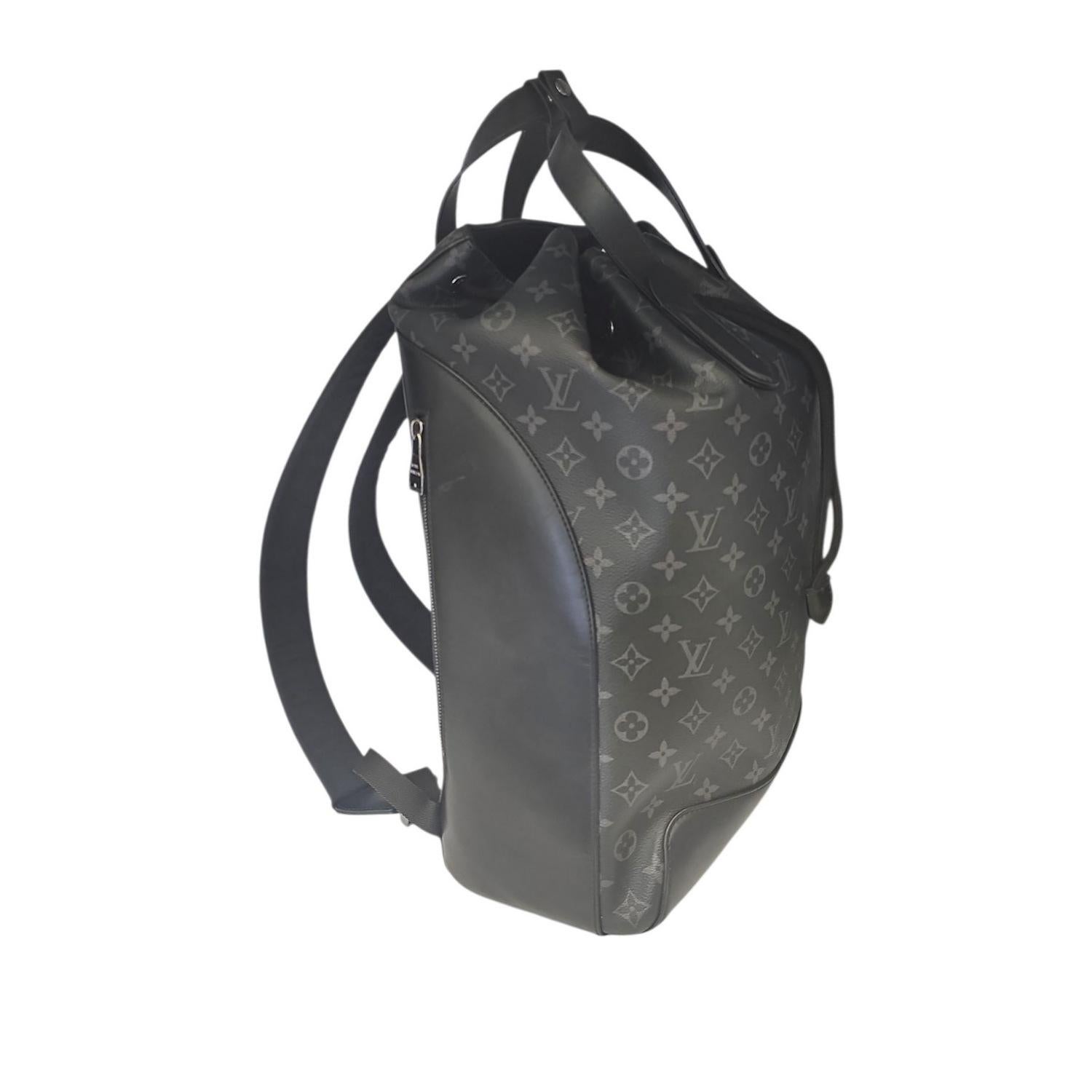 This Louis Vuitton Monogram Eclipse Explorer Backpack is finely crafted of eclipse canvas. The pack features black leather trim, a drawstring top opening and adjustable canvas shoulder straps. The top opens to a black fabric interior with a flat