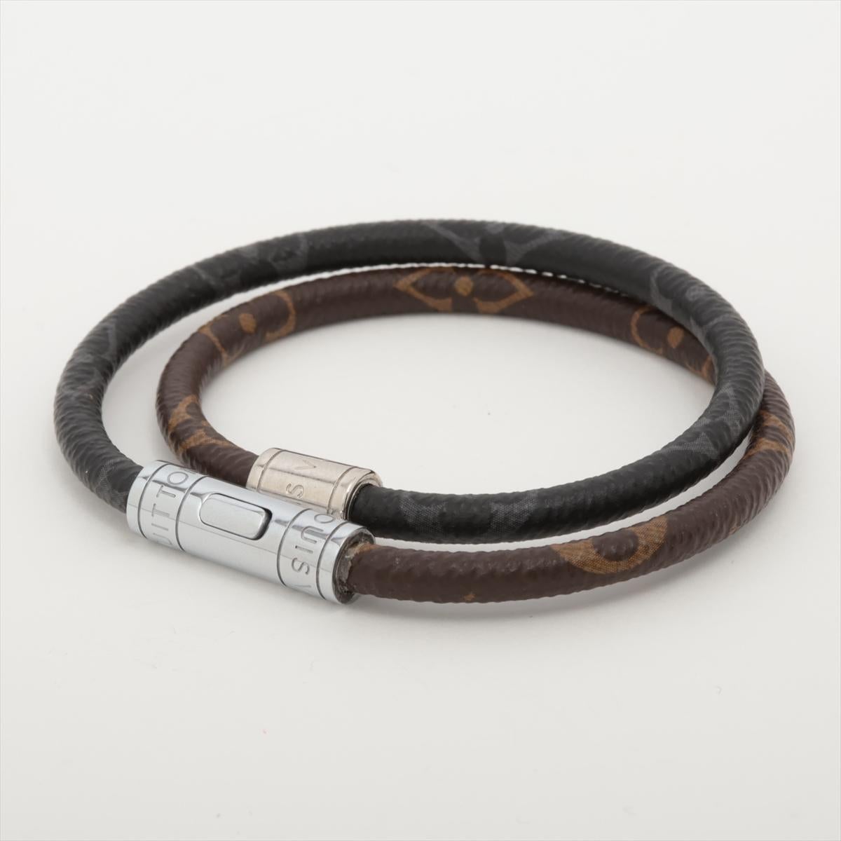 The Louis Vuitton Monogram Eclipse Keep It Double Leather Bracelet is a sleek and stylish accessory that seamlessly combines sophistication with modern edge. Featuring a dual-layer design, it showcases the iconic Monogram Canvas paired with the