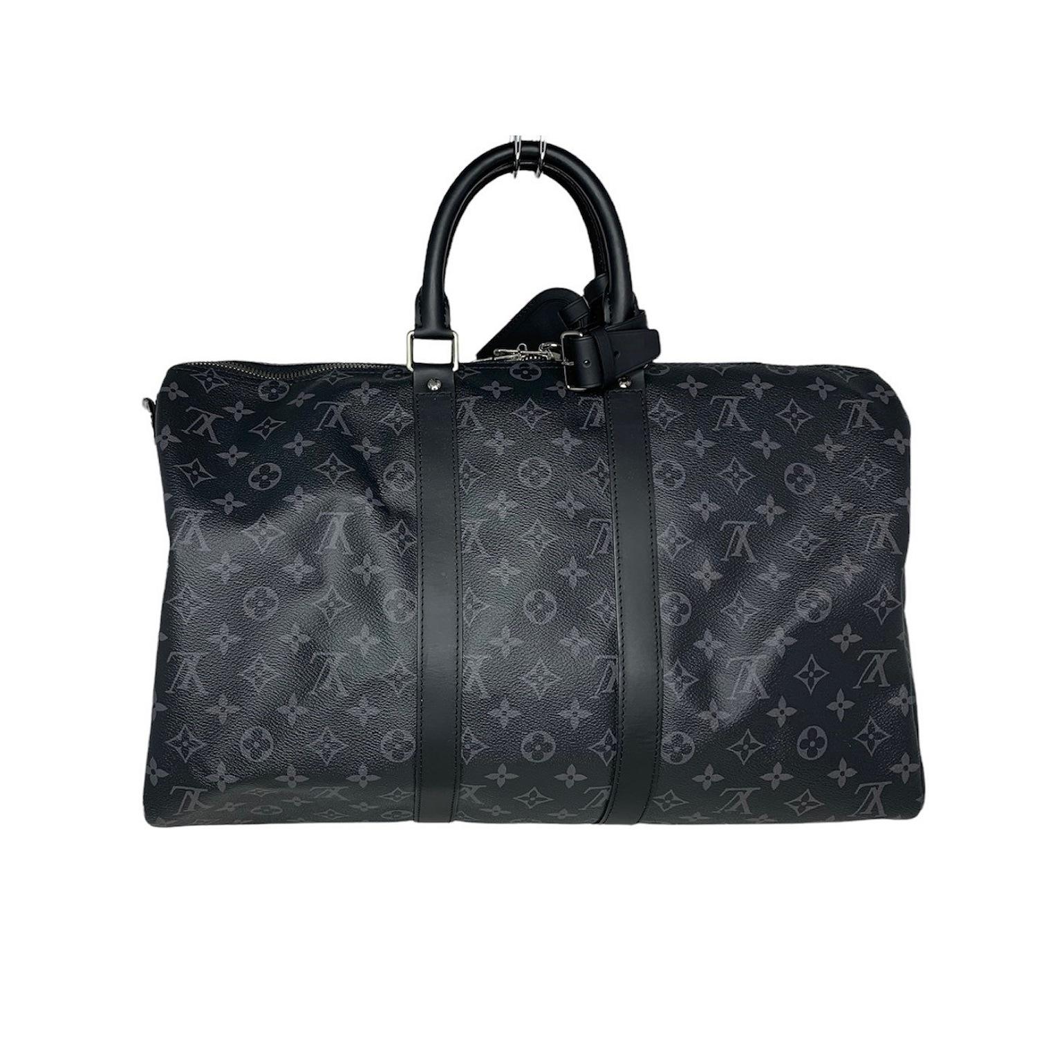 From the 2017 Collection. Men's black and charcoal monogram Eclipse coated canvas Louis Vuitton Keepall Bandouliere 45 with gunmetal hardware, black leather trim, dual rolled top handles, tonal canvas lining, single interior zip pocket and two-way