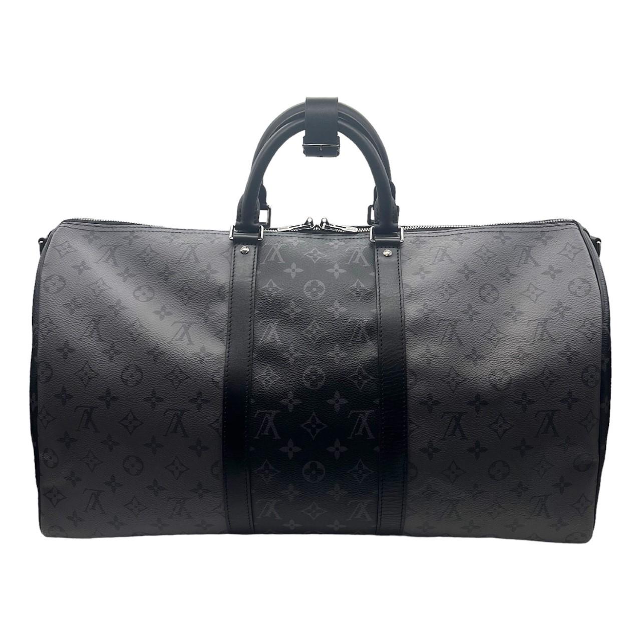 We are offering this very stunning Louis Vuitton travel bag. Made in France, this bag is finely crafted with a combination of Louis Vuitton's dark Monogram Eclipse coated canvas and the lighter Monogram Eclipse Reverse coated canvas with black