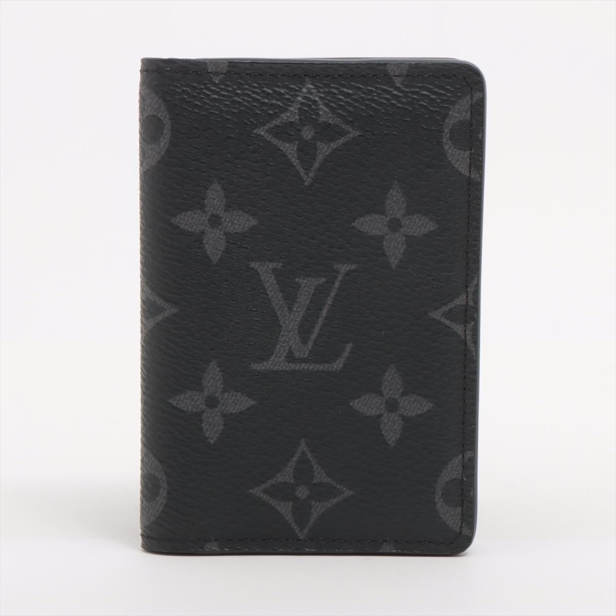 The Louis Vuitton Monogram Eclipse Pocket Organizer is a sleek and compact all-in-one wallet designed for modern functionality. Crafted from the distinctive Monogram Eclipse canvas, it features a sophisticated black and grey color scheme. Despite