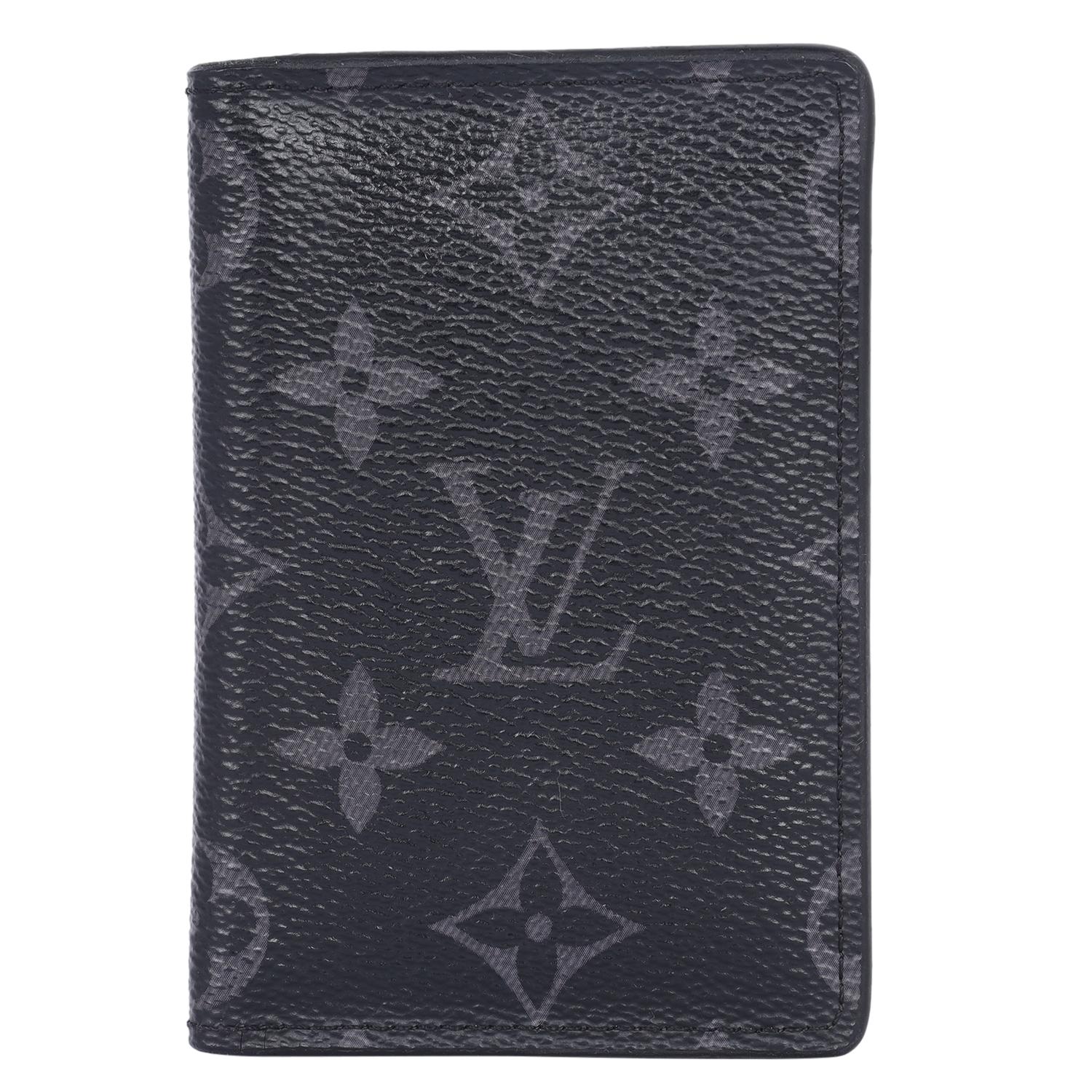 Authentic, pre owned Louis Vuitton black monogram eclipse pocket organizer wallet. Features Louis Vuitton monogram canvas in back and grey. The front flap opens to a black cross grain leather interior that has 3 patch pockets and 4 credit card
