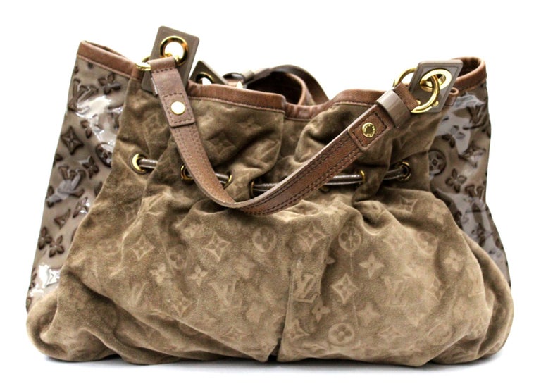 This authentic Louis Vuitton Irene Handbag Monogram Embossed Suede and Patent presented in the brand's Spring/Summer 2009 Collection showcases a classic design with a modern, eye-catching twist. Crafted from light brown monogram embossed suede with
