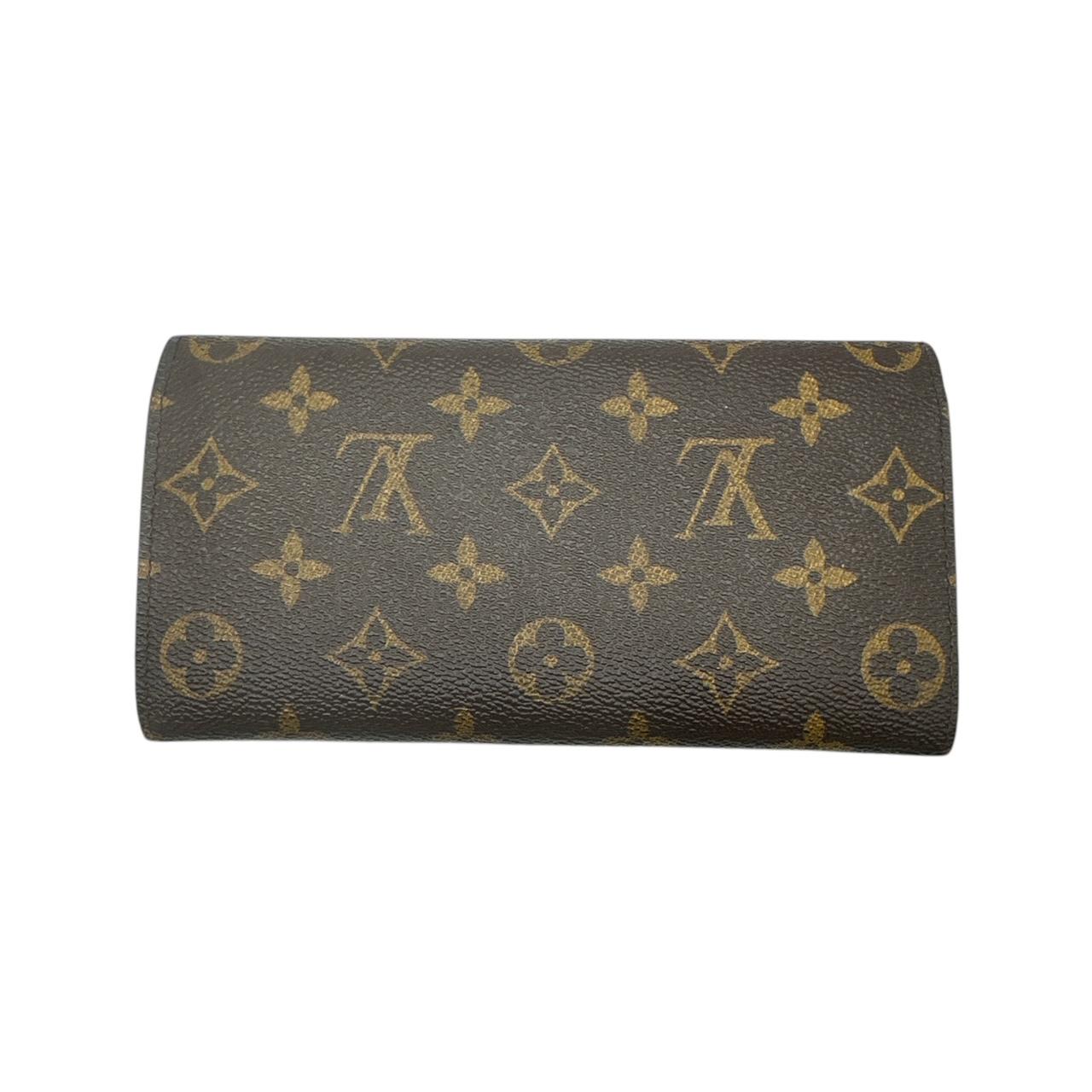 Experience luxury with the Louis Vuitton Monogram Emilie Wallet Rose Ballerine. Made with the brand's iconic monogram coated canvas in a rich brown hue, this wallet boasts a chic envelope-style flap with a charming ballerina pink snap closure.