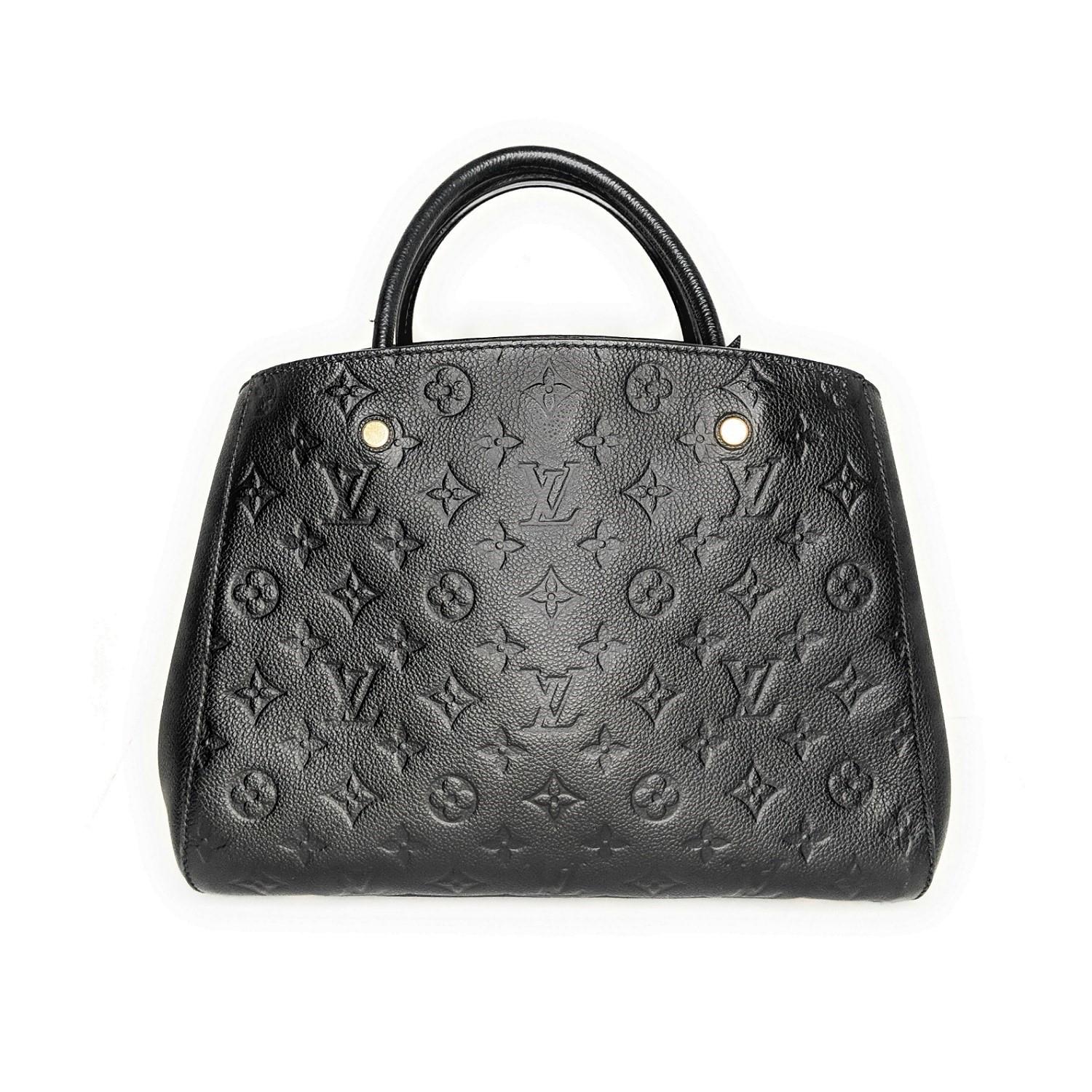 This chic shoulder bag is crafted of Louis Vuitton monogram embossed leather in black. The handbag features rolled leather top handles with brass links, an optional leather shoulder strap with brass clasps, and a broad open-top, revealing a striped