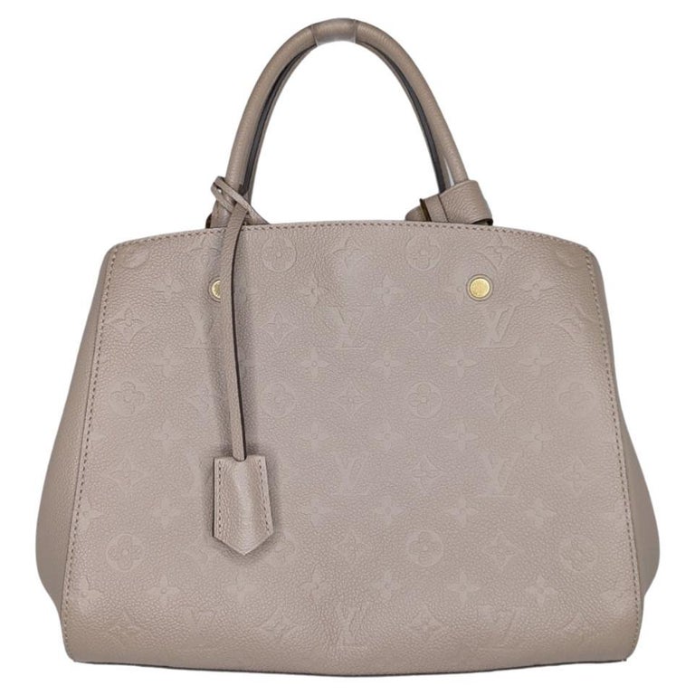 Montaigne MM Top handle bag in Monogram Empreinte leather, Gold Hardwa