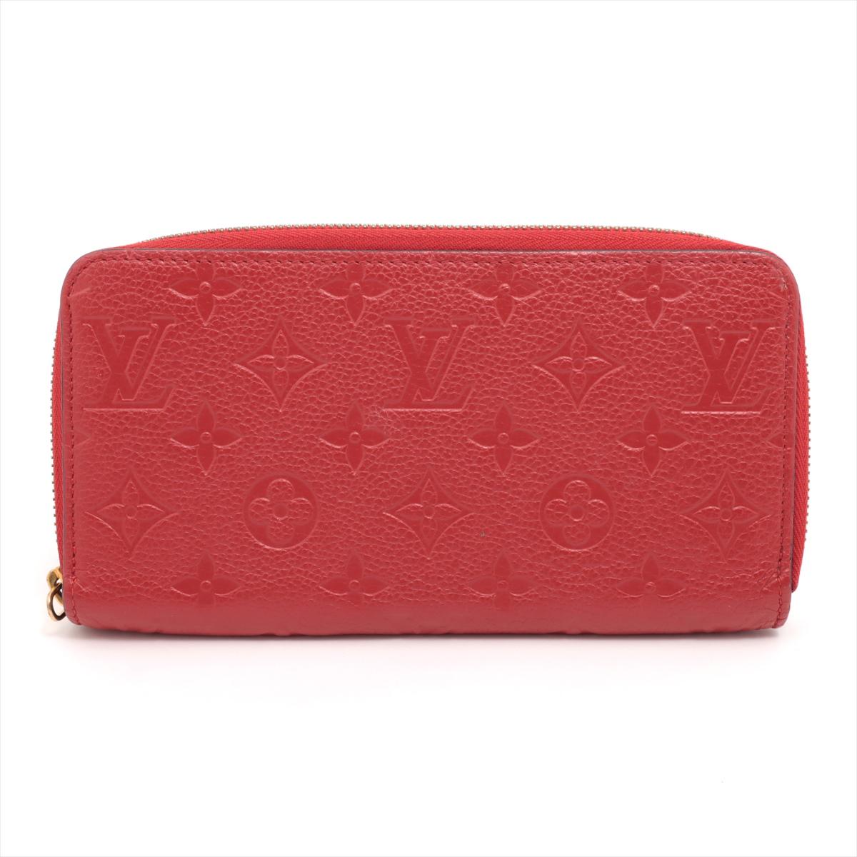 The Louis Vuitton Monogram Empreinte Zippy Wallet in bold red is the epitome of luxury and sophistication. Crafted from the finest Monogram Empreinte leather, it showcases the iconic Louis Vuitton monogram pattern embossed onto supple calf leather,