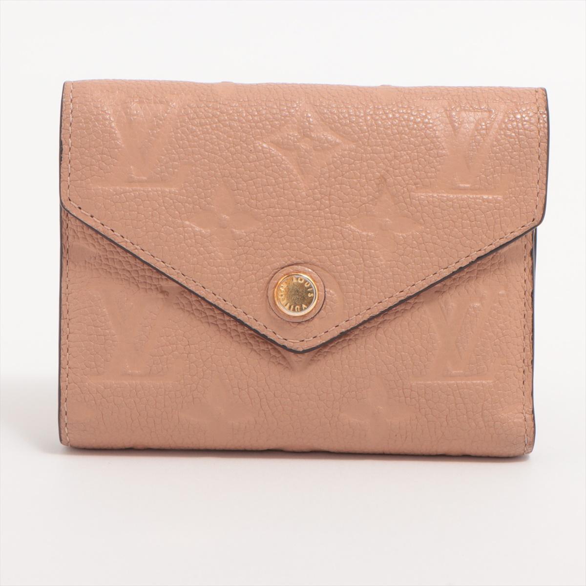 The Louis Vuitton Monogram Empreinte Zoé Wallet in Pink Beige a luxurious and stylish accessory that perfectly blends modern design with the iconic Monogram Empreinte pattern. The wallet features sumptuous pink beige leather embossed with the