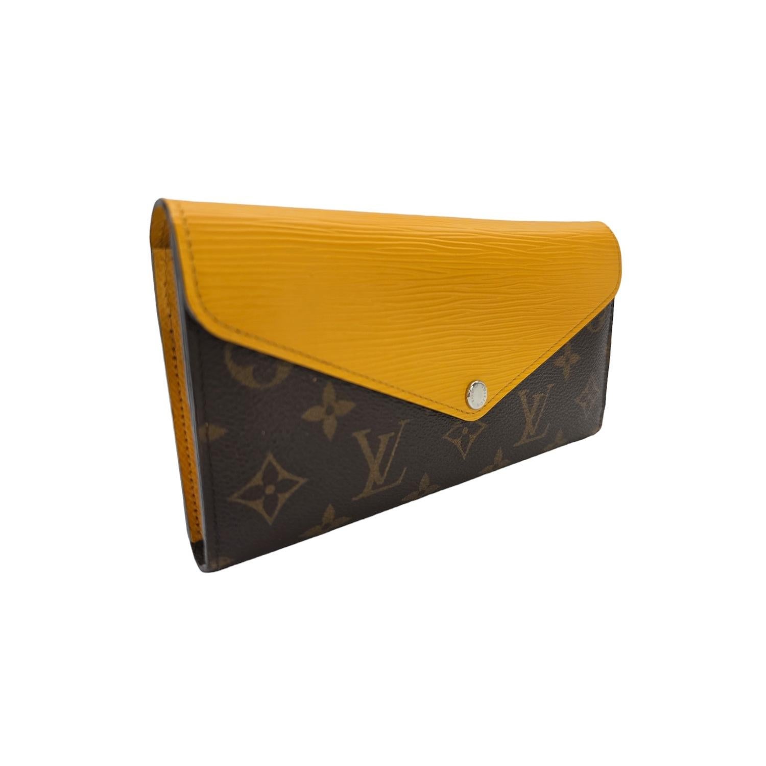 Indulge in luxury with the Louis Vuitton Monogram Epi Marie Lou Long Wallet. Featuring a timeless monogram coated canvas and a striking Epi leather flap in Mimosa Yellow, this wallet combines style and functionality. With multiple card slots,