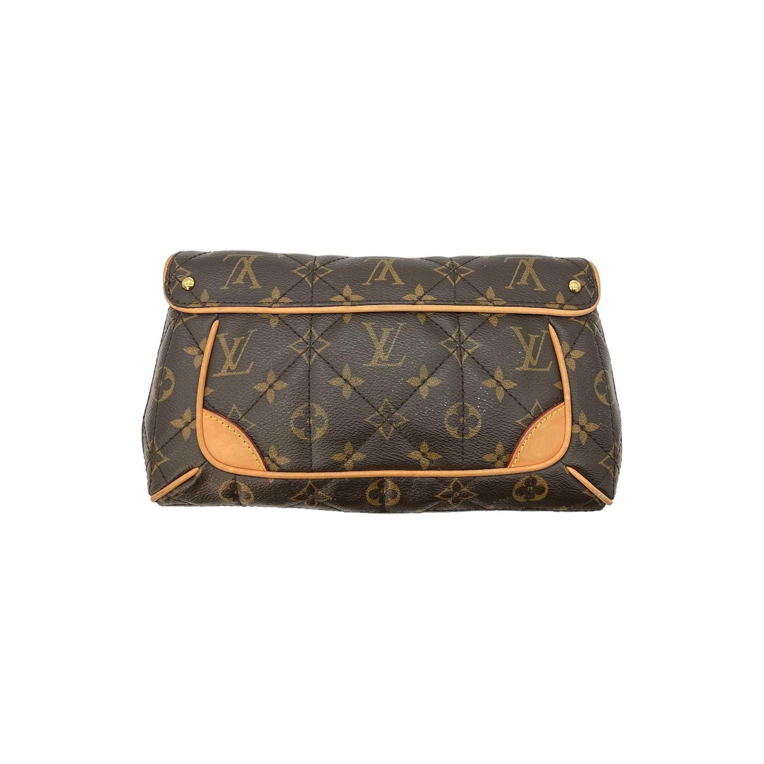 This Louis Vuitton Monogram Etoile Clutch was made in France in 2009 and it is finely crafted of the classic Louis Vuitton Monogram coated canvas with leather trimming and gold-tone hardware features. It has a locking pull through closure that opens
