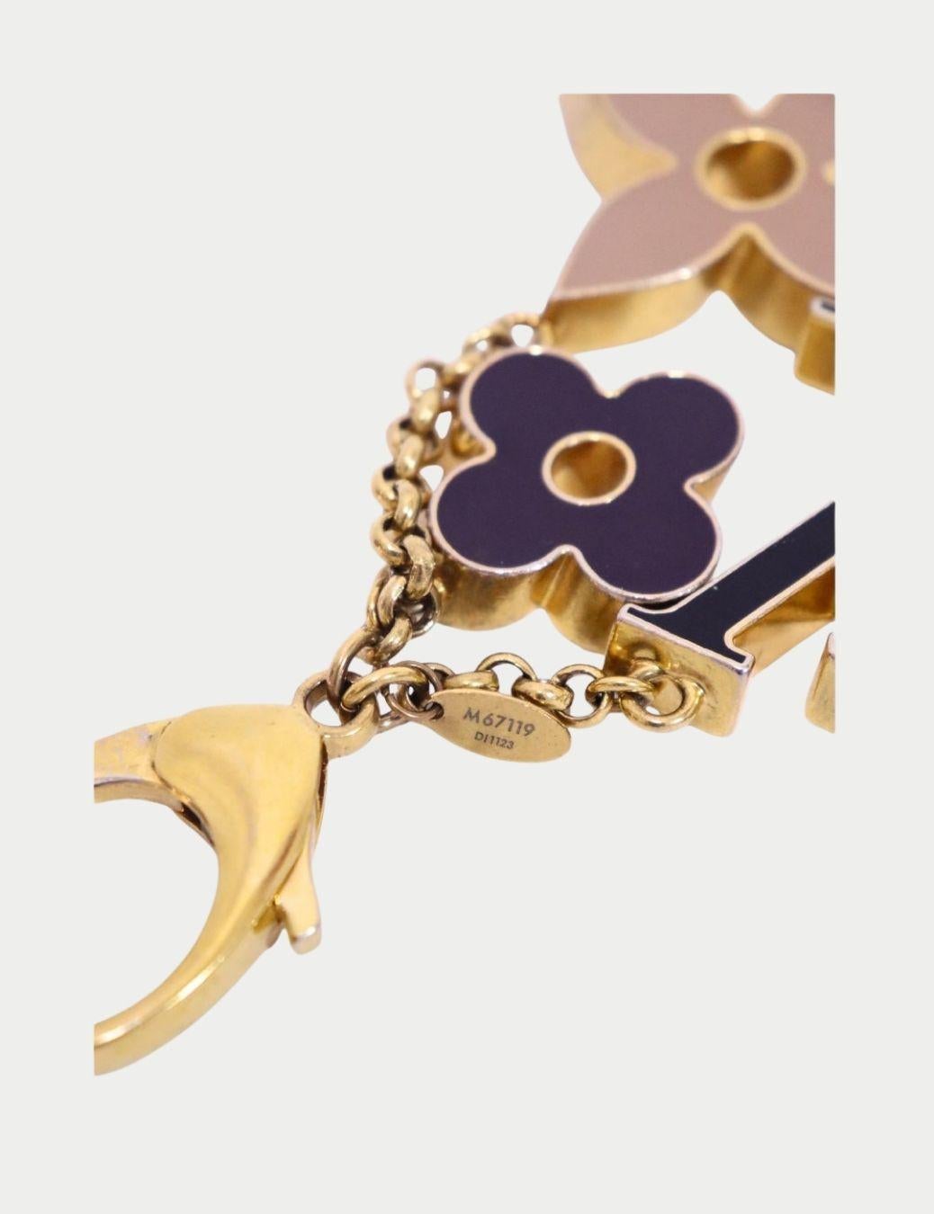 Elevate your handbag with this Louis Vuitton Monogram Flower & LV Initials bag charm. Crafted in gold-tone metal with enamel accents, it features the iconic LV initials alongside two Monogram-inspired flower motifs. The secure clasp easily attaches