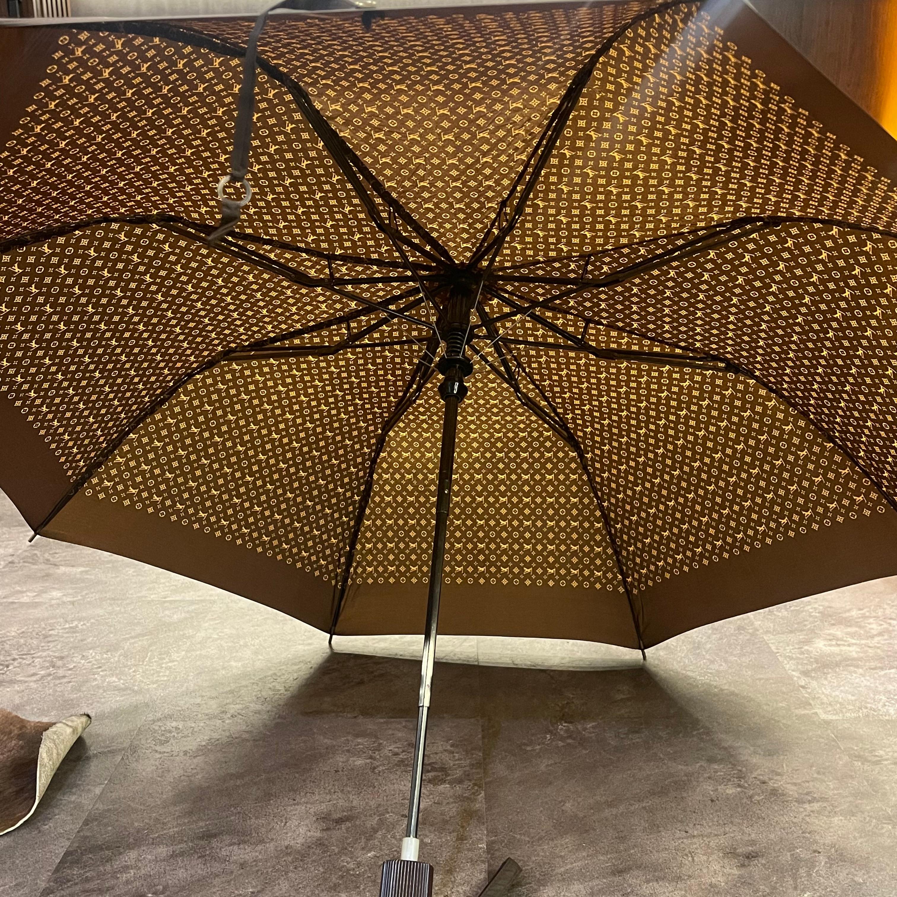 Monogram umbrella with cover. Beautiful collectors piece. Faint oxidation on the hardware. Light scuffing on the plastic handles. 100% polyester.
