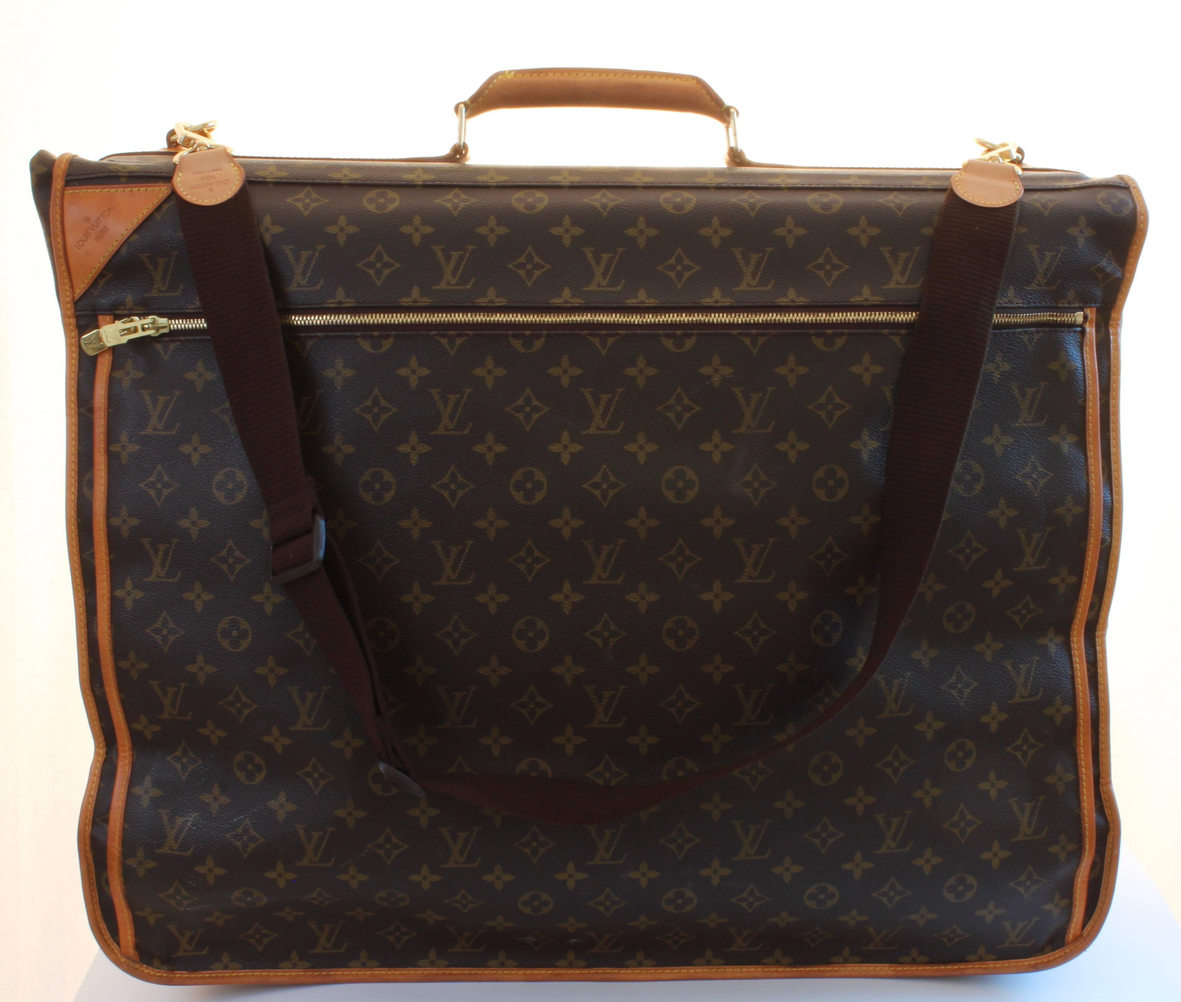 This fabulous travel piece was made by Louis Vuitton in 1999 and it holds a ton!  Crafted of their signature monogram canvas and trimmed in vachetta leather, it features a rolled leather handle and two gold metal LV clasps at each side.  There's a