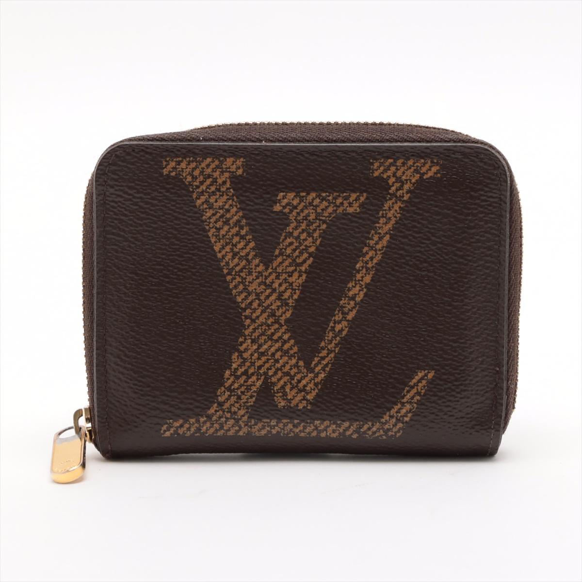 The Louis Vuitton Monogram Giant Reverse Zippy Coin Purse is a bold and stylish compact accessory that showcases a modern twist on the classic monogram design. Crafted from Monogram Giant Reverse canvas, it features oversized LV motifs in