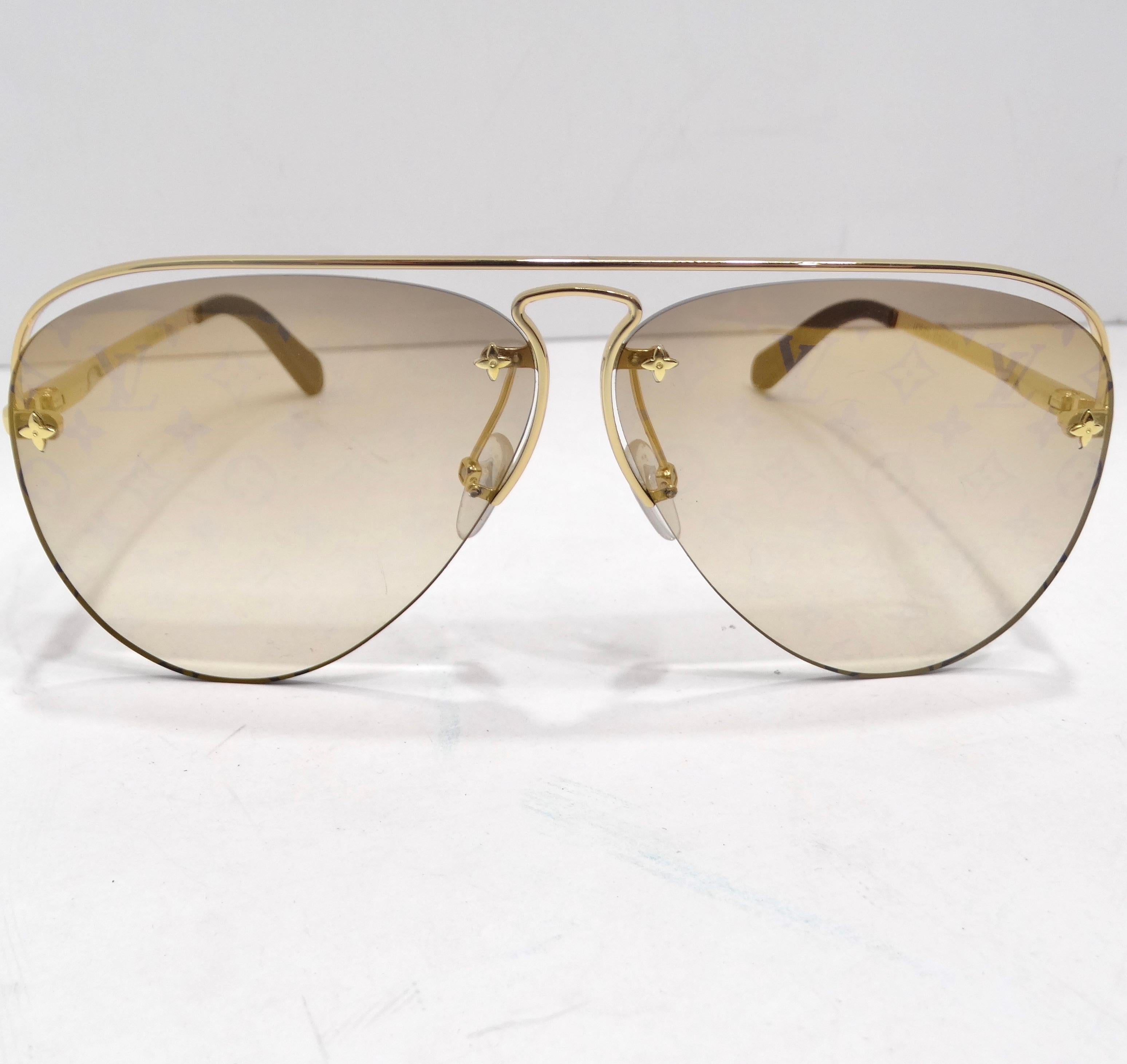 Introducing the Louis Vuitton Monogram Grease Gradient Sunglasses – a harmonious blend of classic aviator style, iconic LV monogram patterns, and elegant detailing. These sunglasses are not just an accessory; they are a chic and timeless statement
