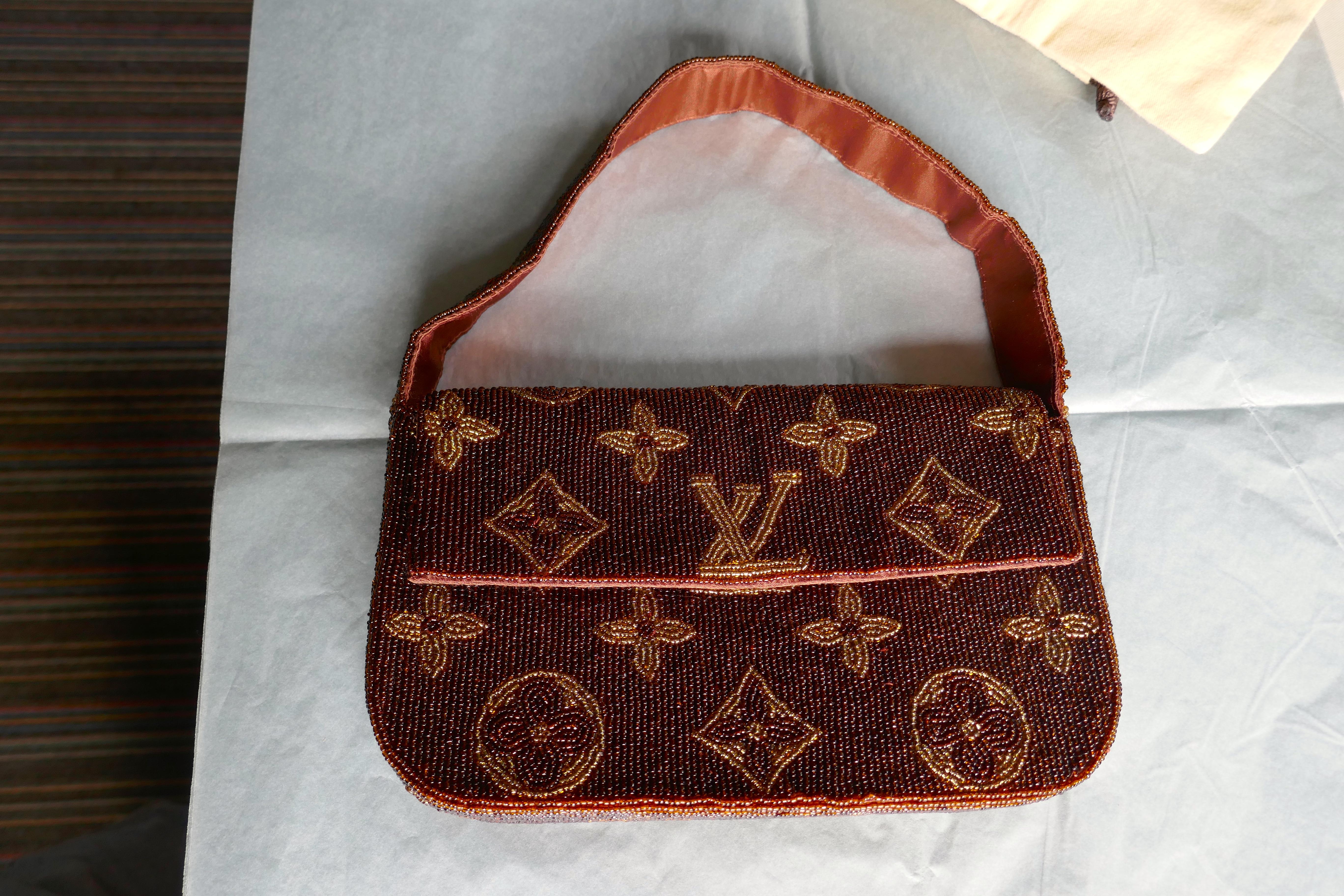 Louis Vuitton Monogram Limited Edition Bead Work Evening Handbag.

This very rare piece dates from the 1970s, the bag is made in Bronze and Gold glass beadwork with the LV monograms sewn in Gold, the bag and its handle are lined in matching Bronze